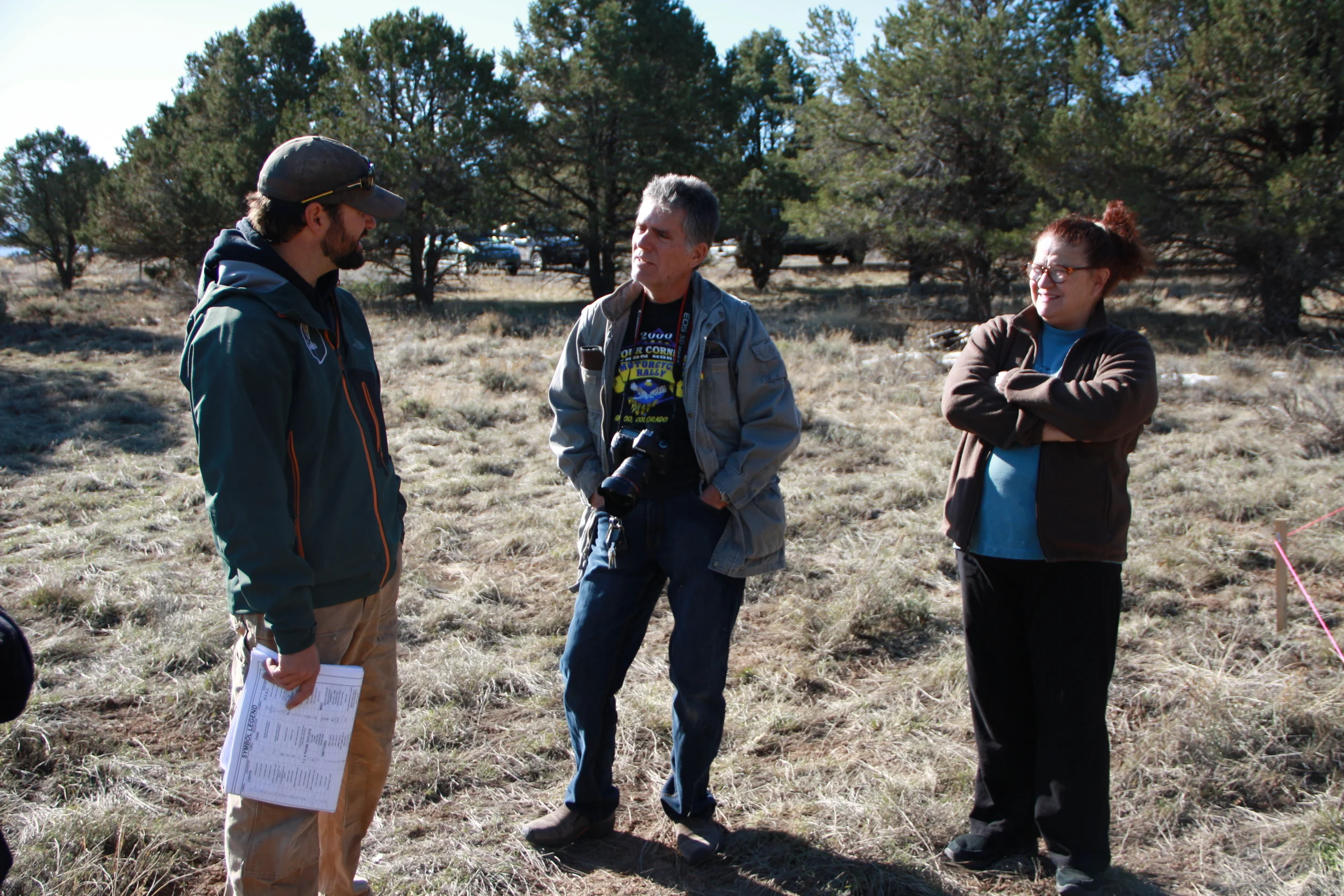 Neighbors up the mesa, Jim and Linda, chatting with Clint and checking out the build site. Jim and Linda run a wonderful air bnb out of their home in Log Hill Village, up the mesa about 10 minutes, which we stayed at for two nights. On the far right you can see one of the stakes.