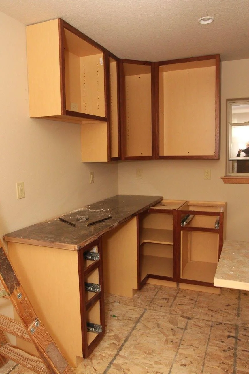 Kitchen cabinets being installed.