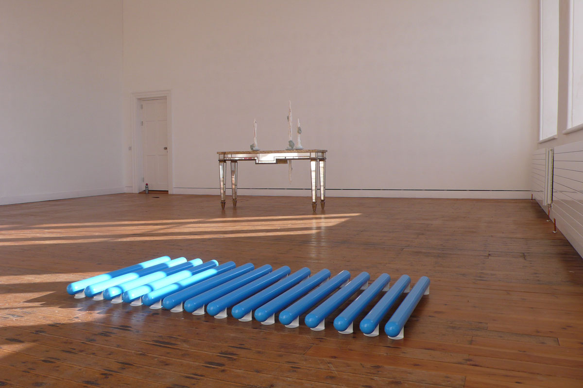 Pipe Dreams 4 2004 carpaint, plastic 15 pipes on stands each pipe 98 x 7 cm, stands 4.7 x 7 cm installation view Discussions in Contemporary Sculpture, The Dock, Carrick-on-Shannon, Ireland, 2008