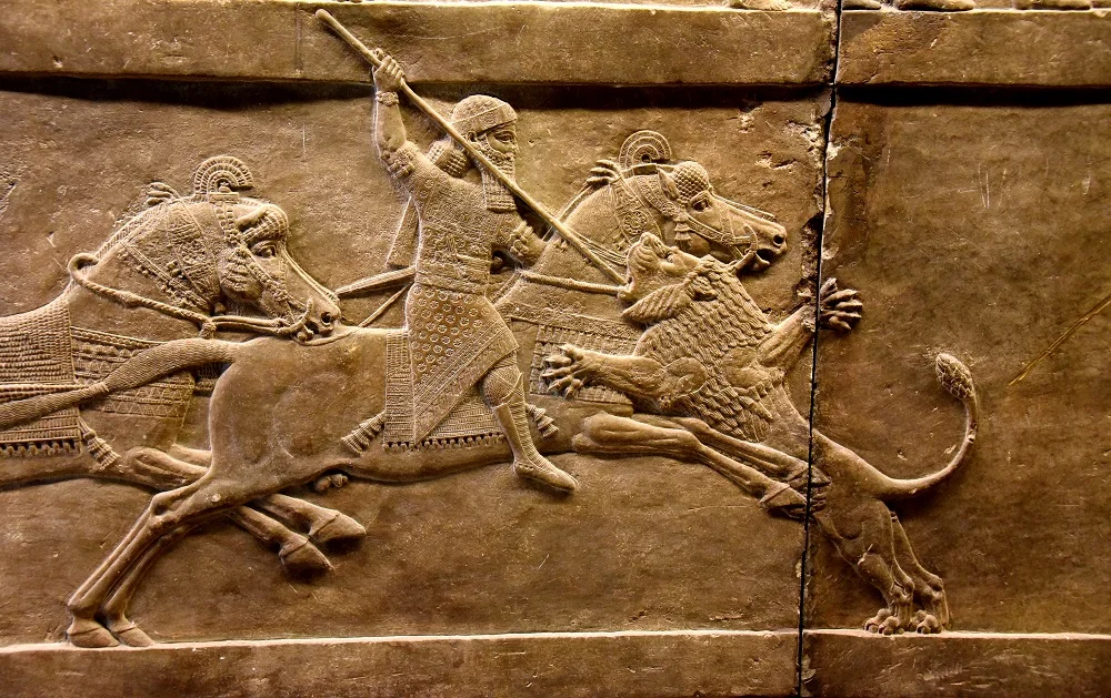 Neo-Assyrian bas-relief from Ninevah of Assyrian king Ashurbanipal slaying a lion | Currently housed in the British Museum, London | Image Source