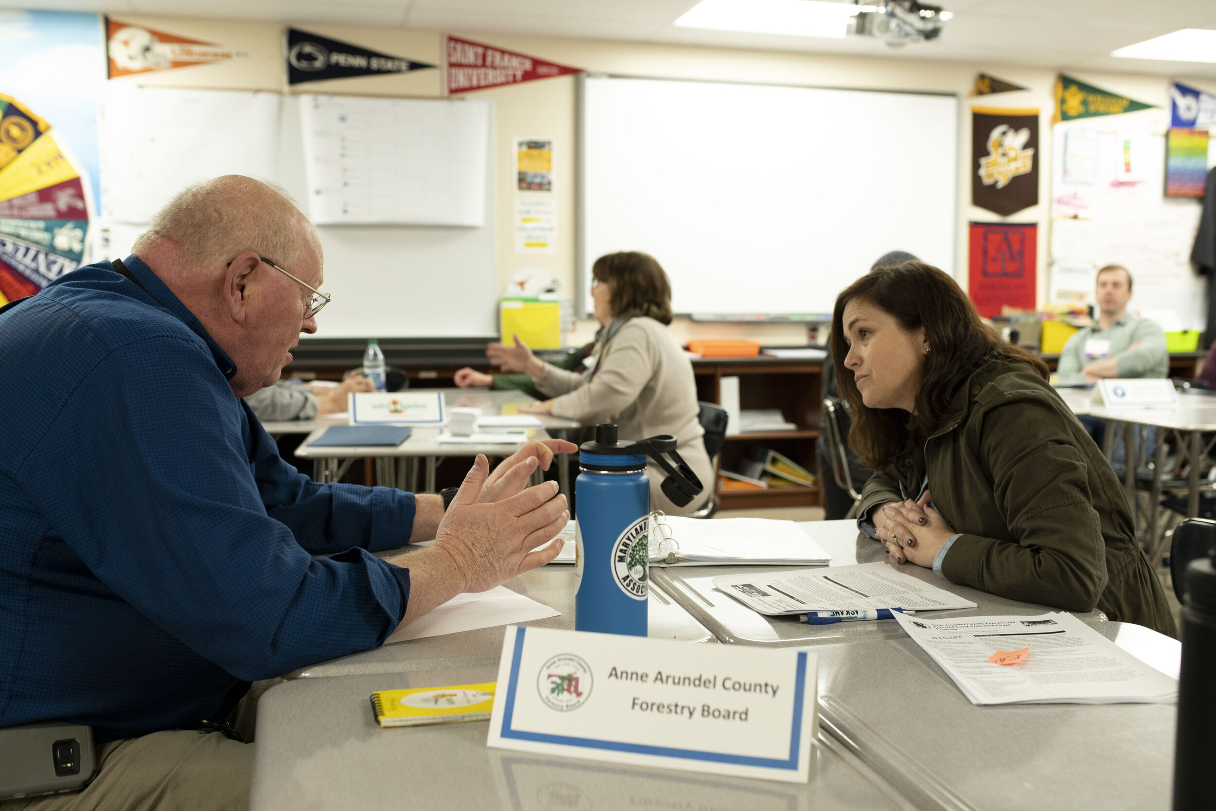 Bud discusses tree planting and invasive removal funding with a WSA conference attendee.