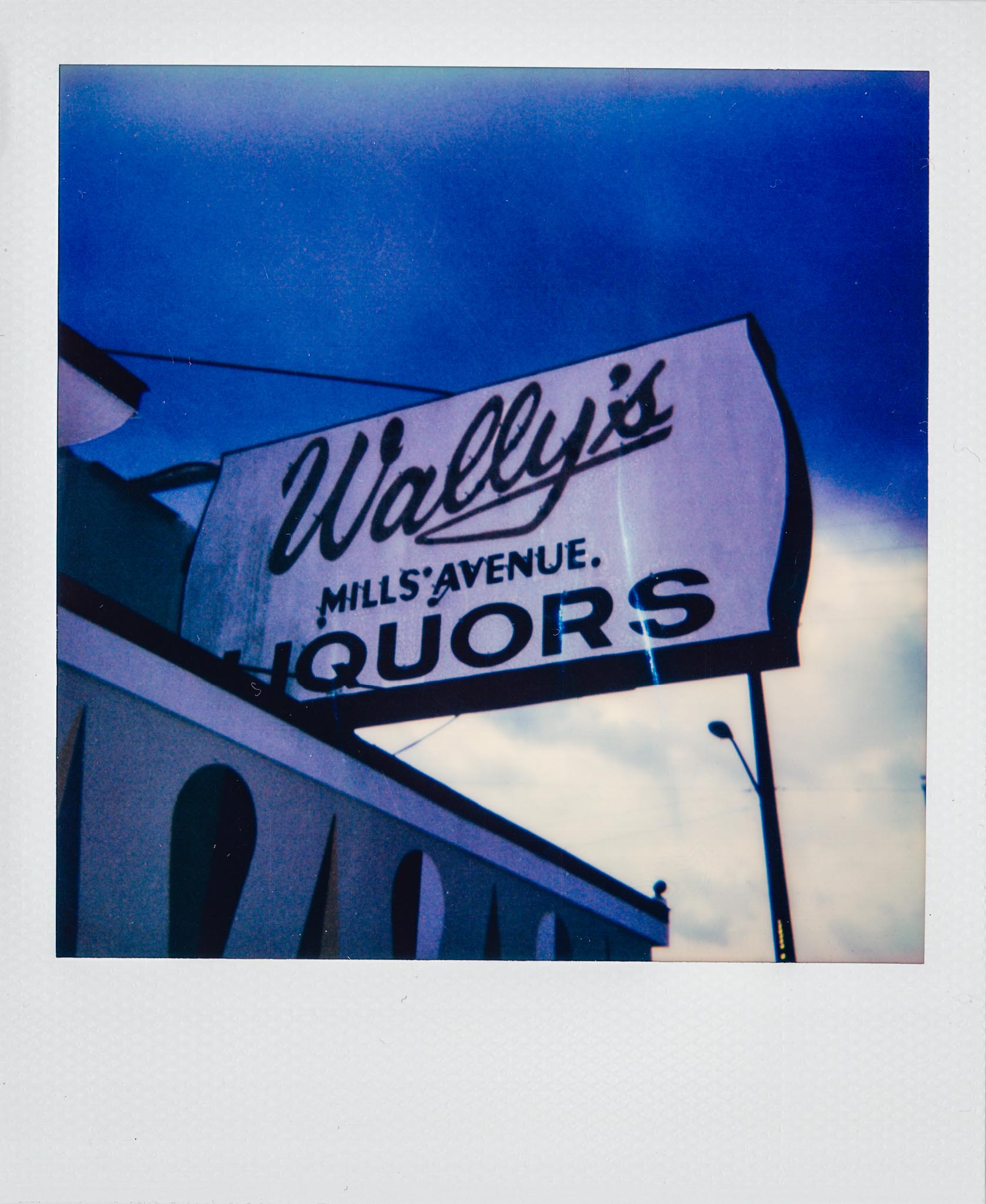 Polaroid of Wally's Mills Avenue Liquors Outdoor Sign