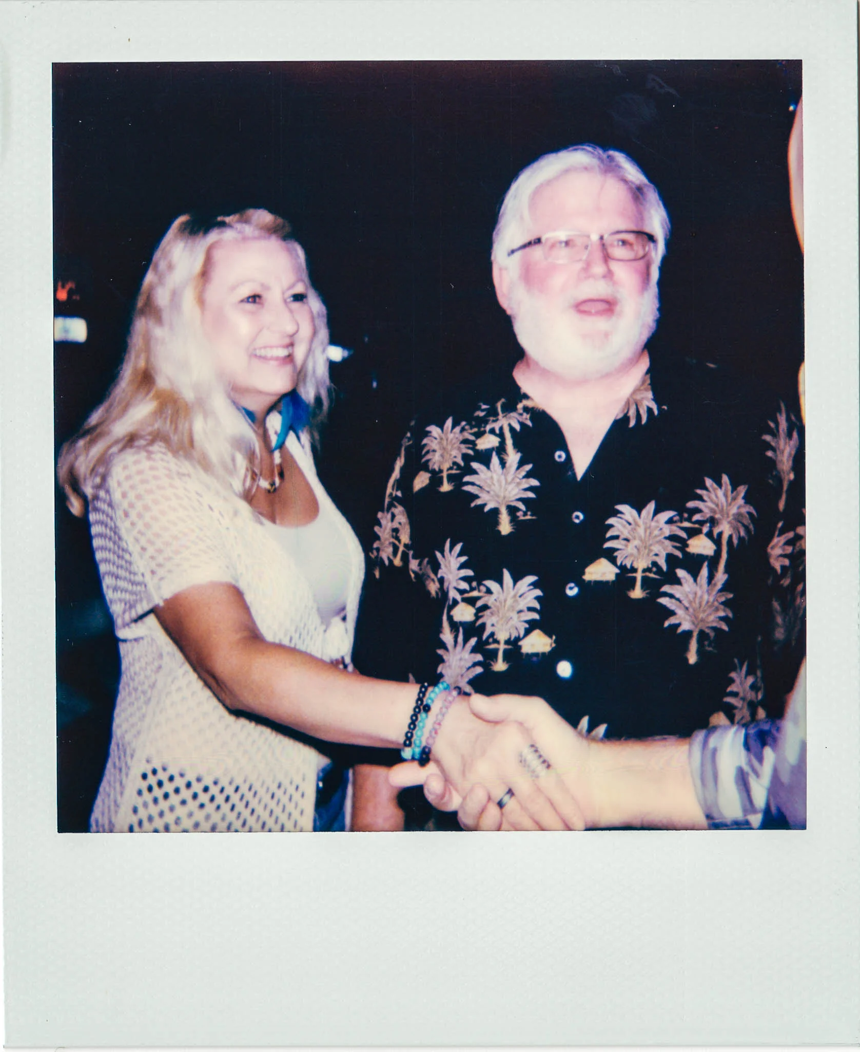 An older couple meeting someone at Wallys Mills Avenue Liquors