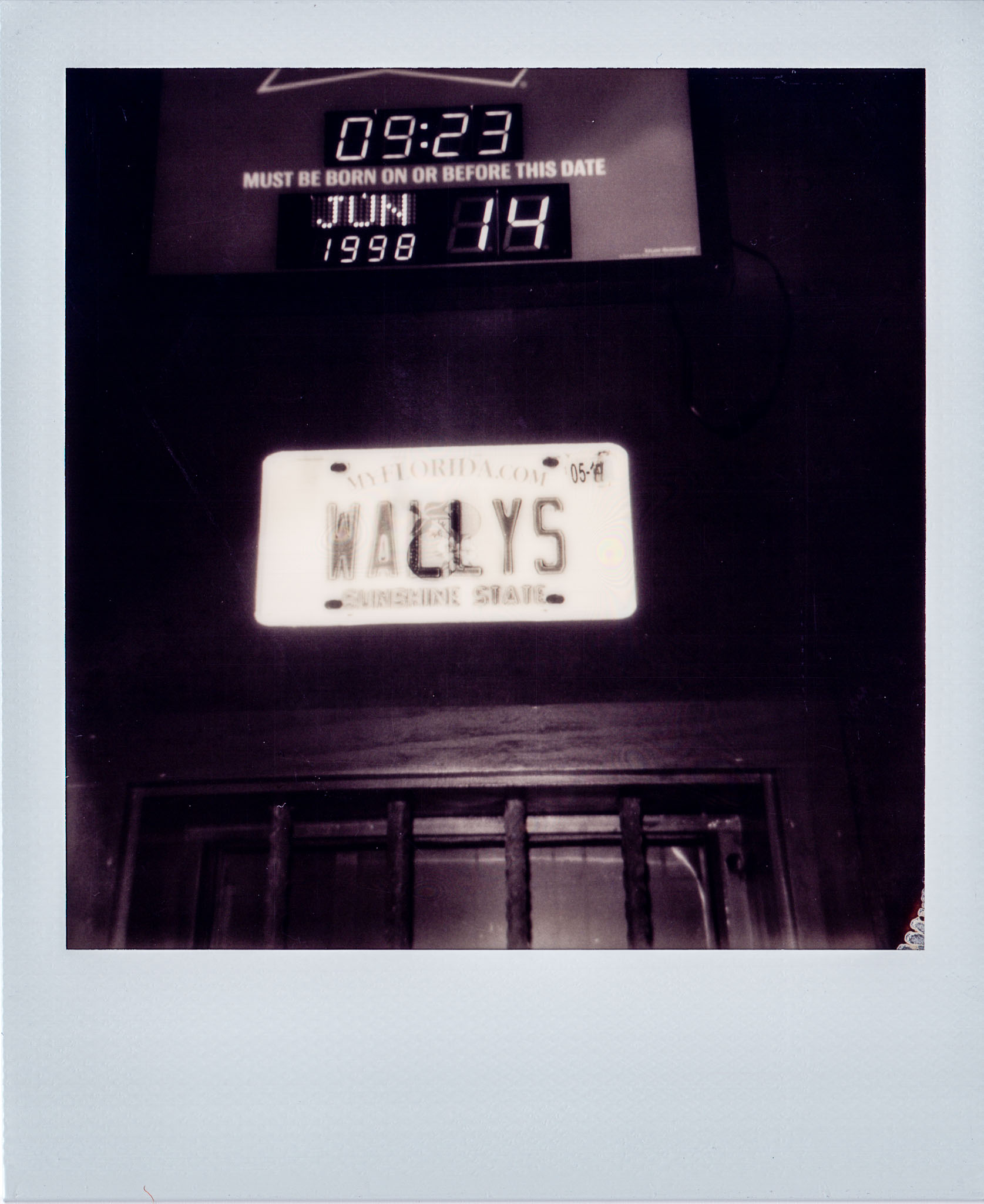 Wallys license hanging above the bar at Wallys Mills Avenue Liquors
