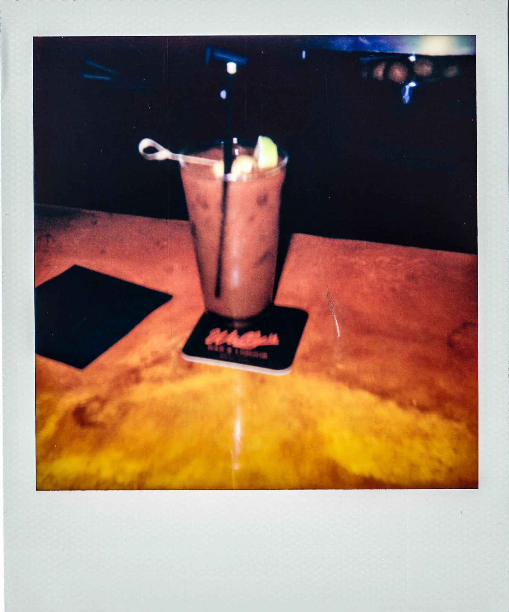 A bloody mary on a coaster at Wallys Mils Avenue Liquors
