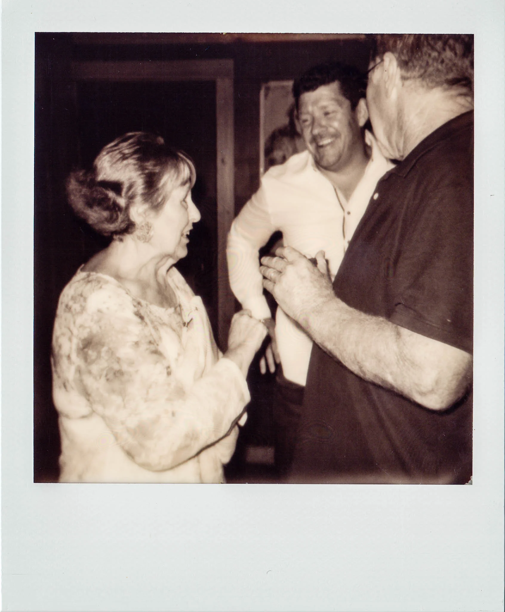 Linda Updike talking with friends at Wallys Mills Avenue Liquors.