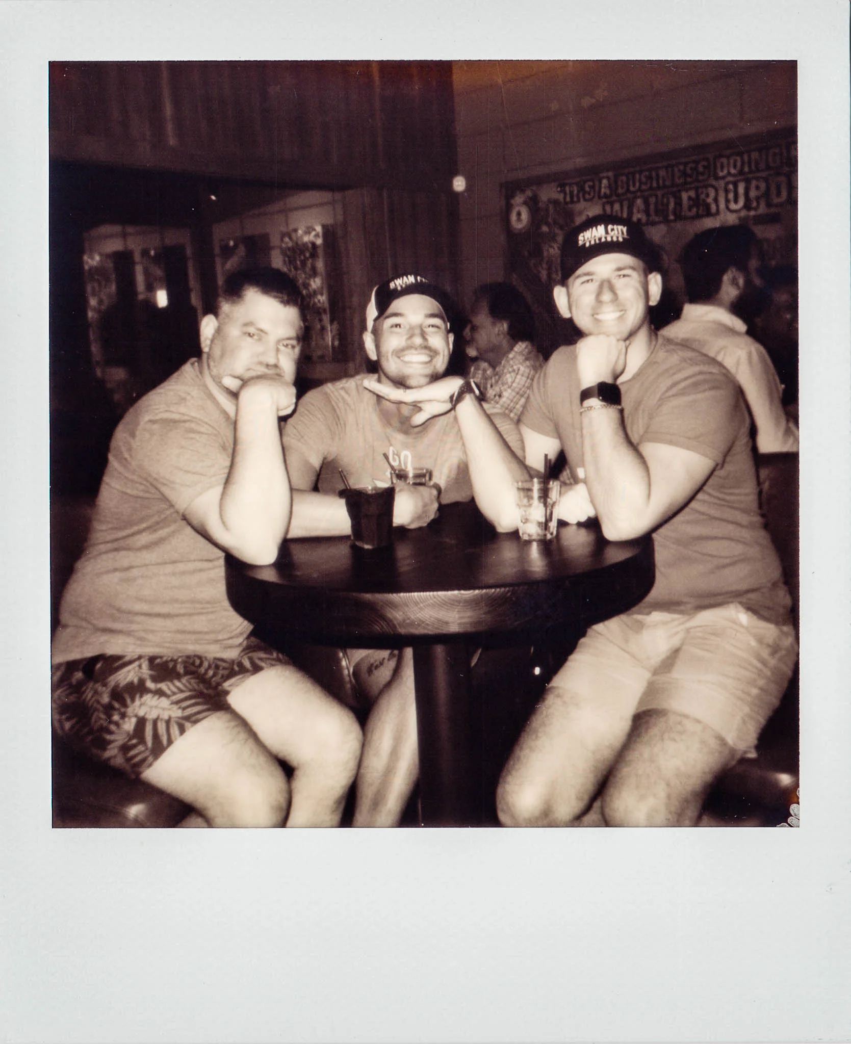 Swan City Shirts guys sitting together at Wallys Mills Avenue Liquors