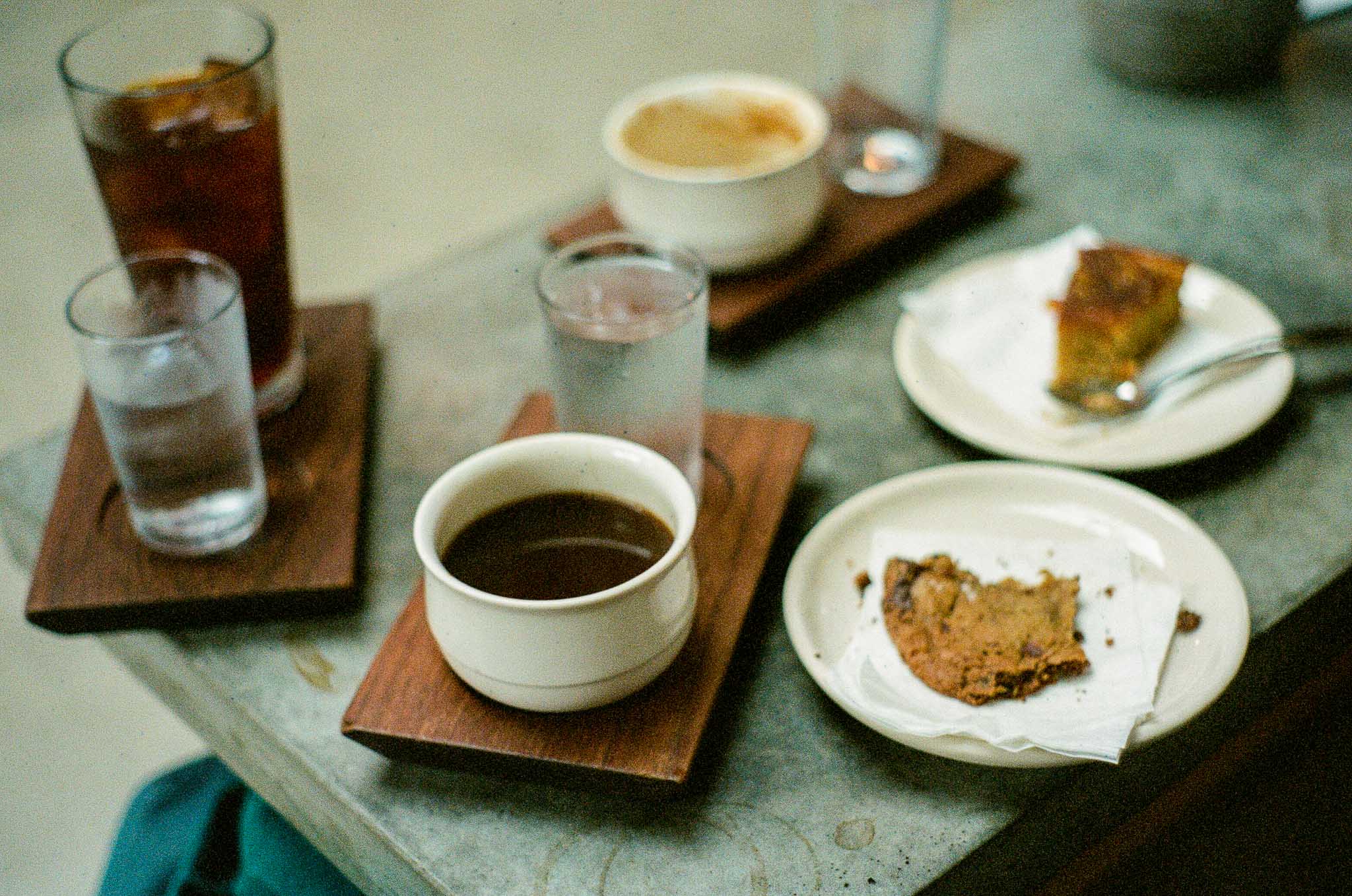 A table filled with wooden platters and plates of coffee and pastries at Sey Coffee in Brooklyn New York