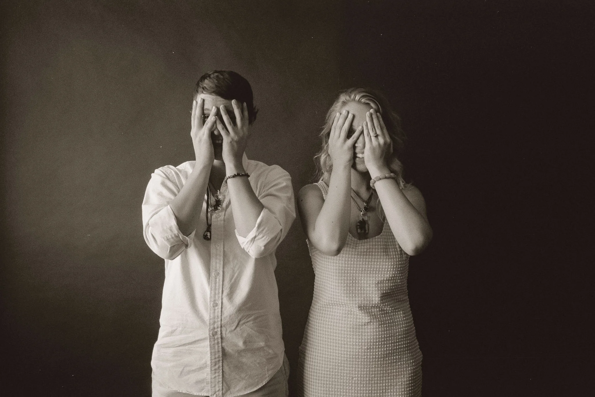 Guy and Girl covering their face
