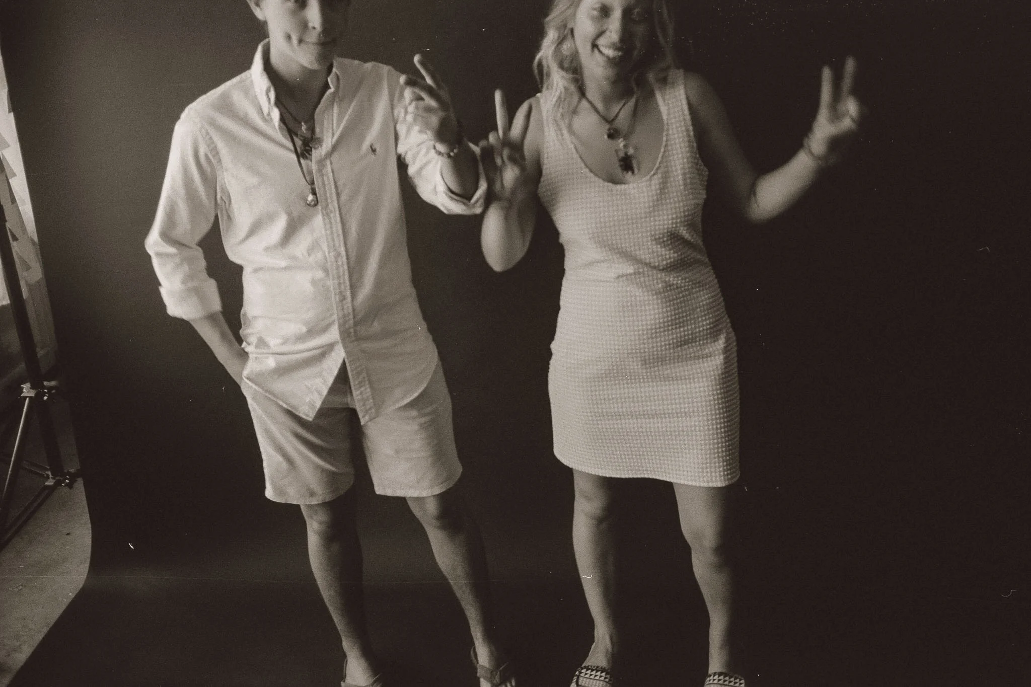 Guy and girl holding up peace signs
