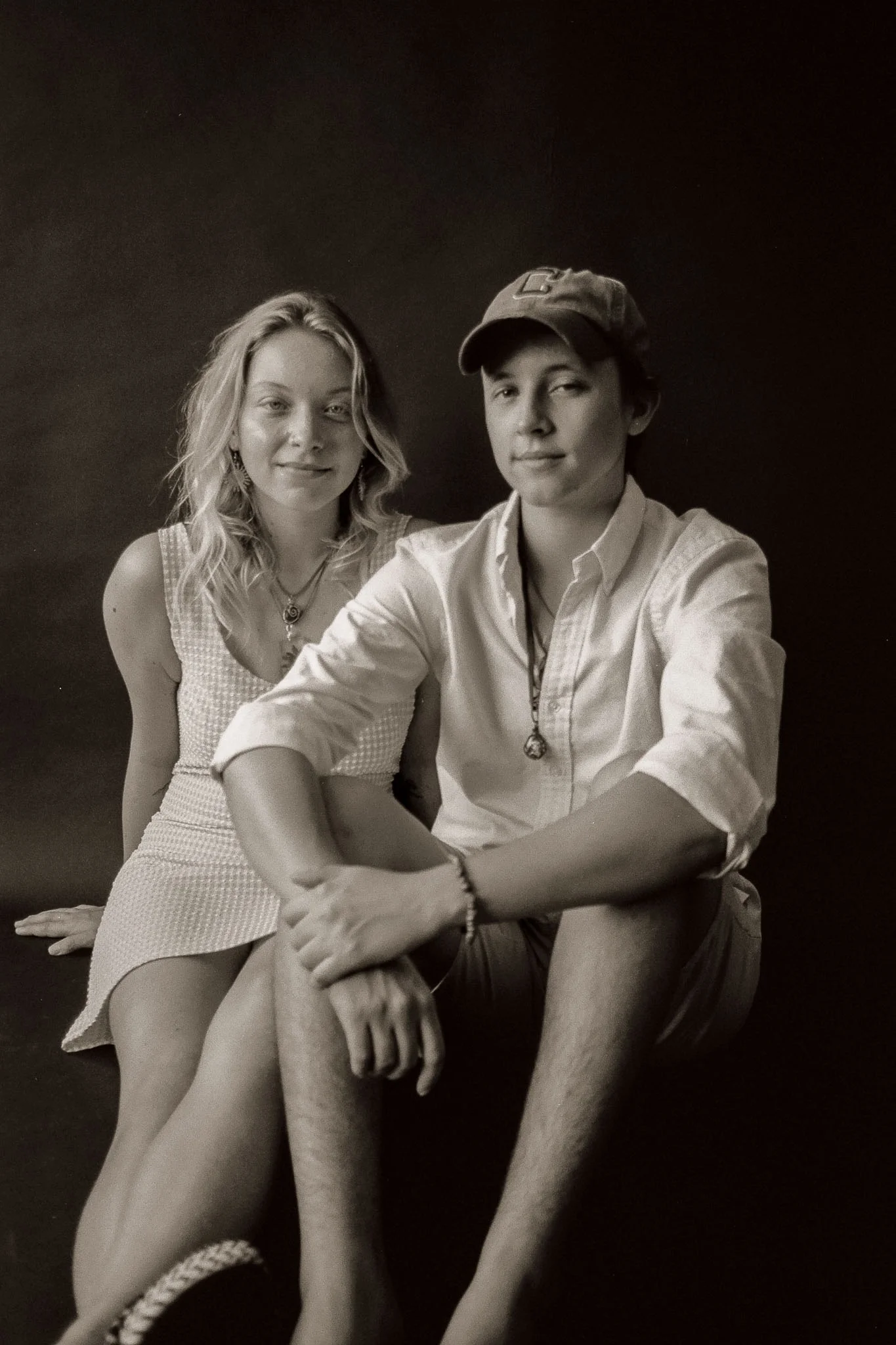 Guy and girl sitting looking serious