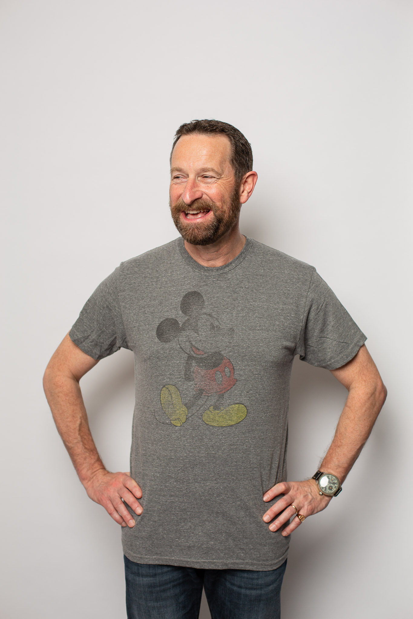  Duncan Wardle on a white backdrop with a grey Mickey Mouse T Shirt.  