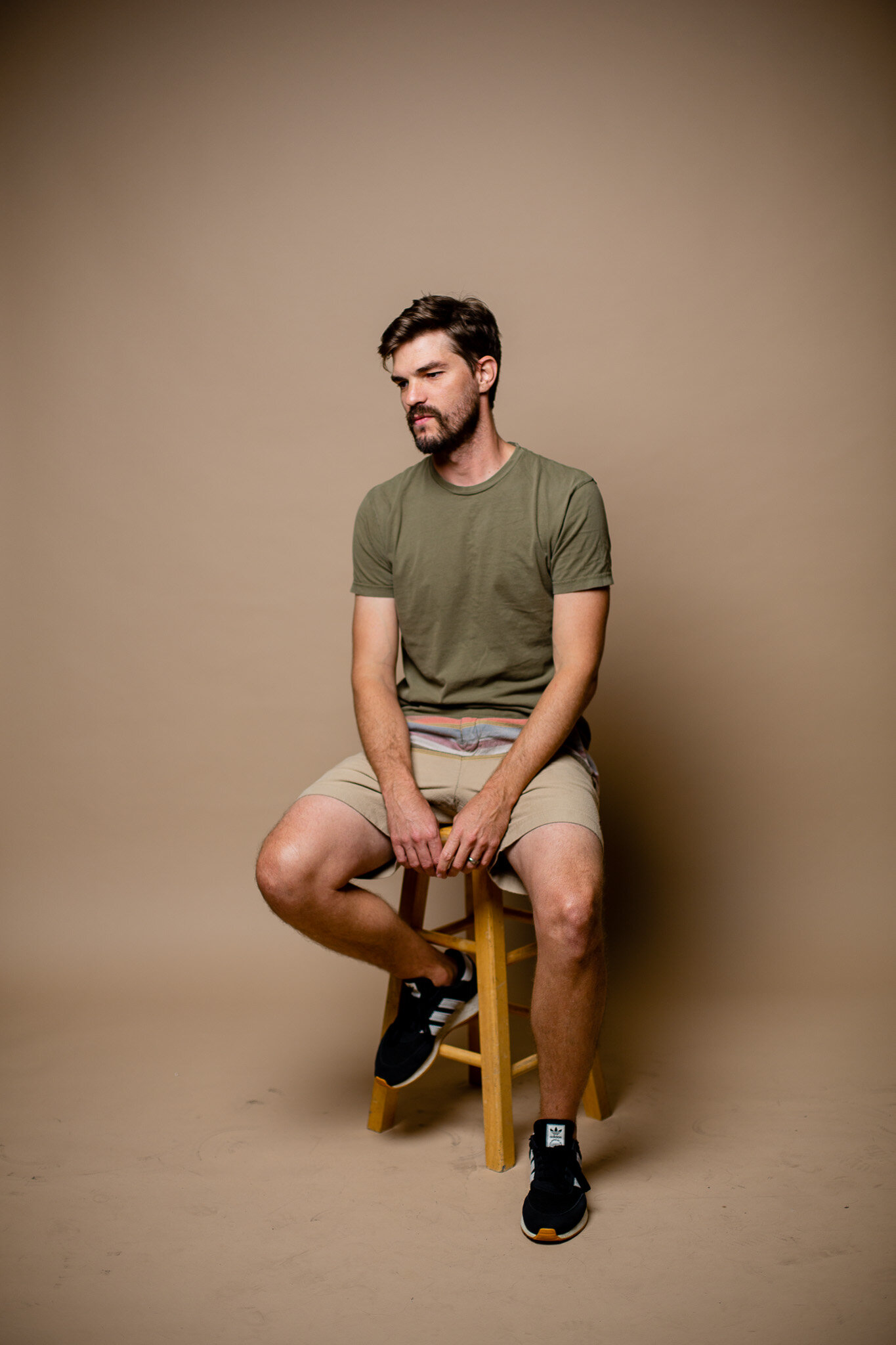 Joel Setzer sitting on a stool and looking to the side
