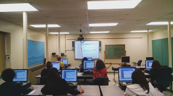 An ESL class gaining computers skills while working on English grammar exercises.