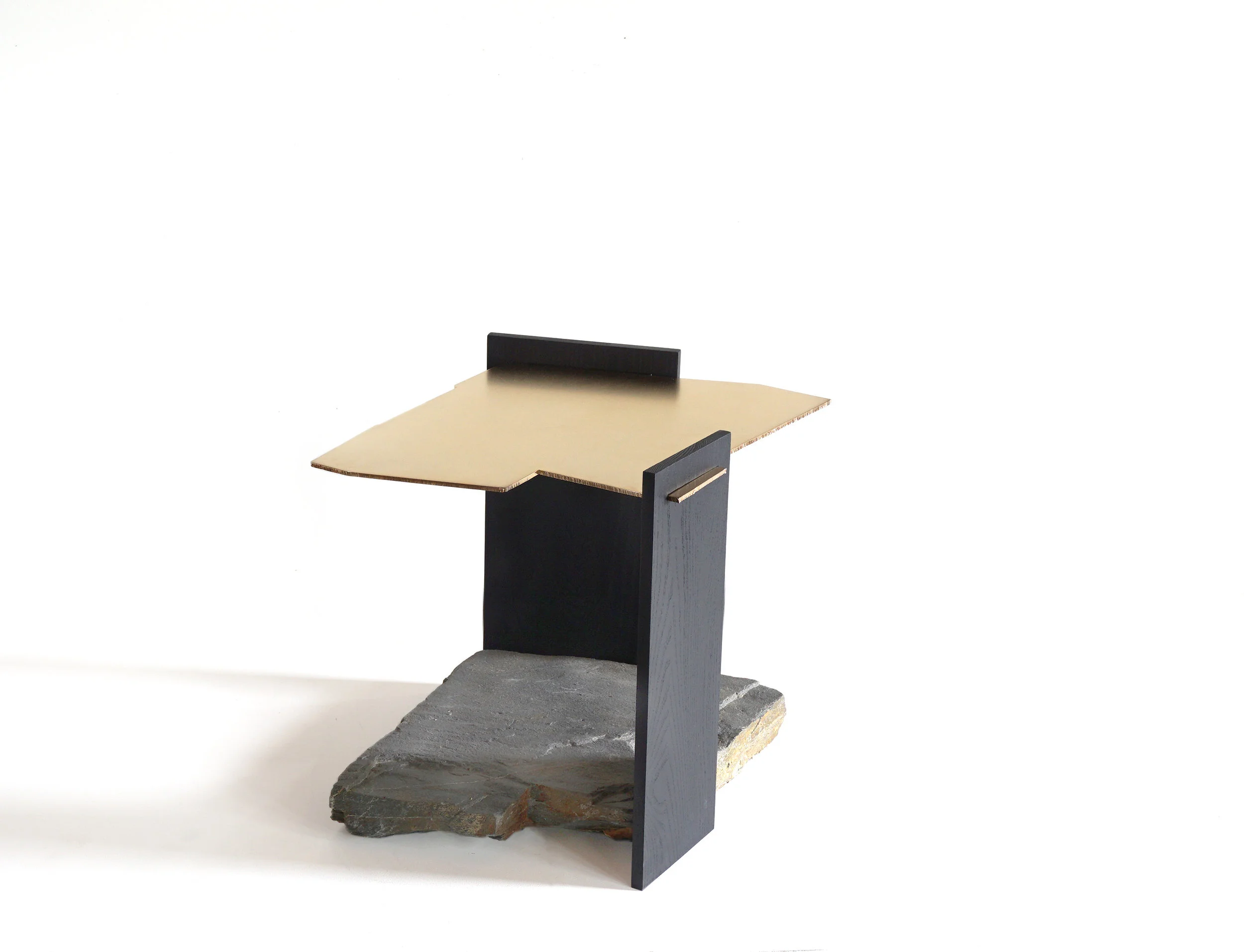 The Missisquoi 04 table is one of a kind table made of stone, gold plated steel and blackened Ash. The geometry of the stone’s perimeter was plasma cut into a gold plated steel plate, hovering above the stone to mirror its origins. 2017, one of a kind, Solid blackened ash, found stone from the Missisquoi valley, gold plated steel. dimensions: 17.75” H x 15.75” W x 19” D ©Simon Johns 2017