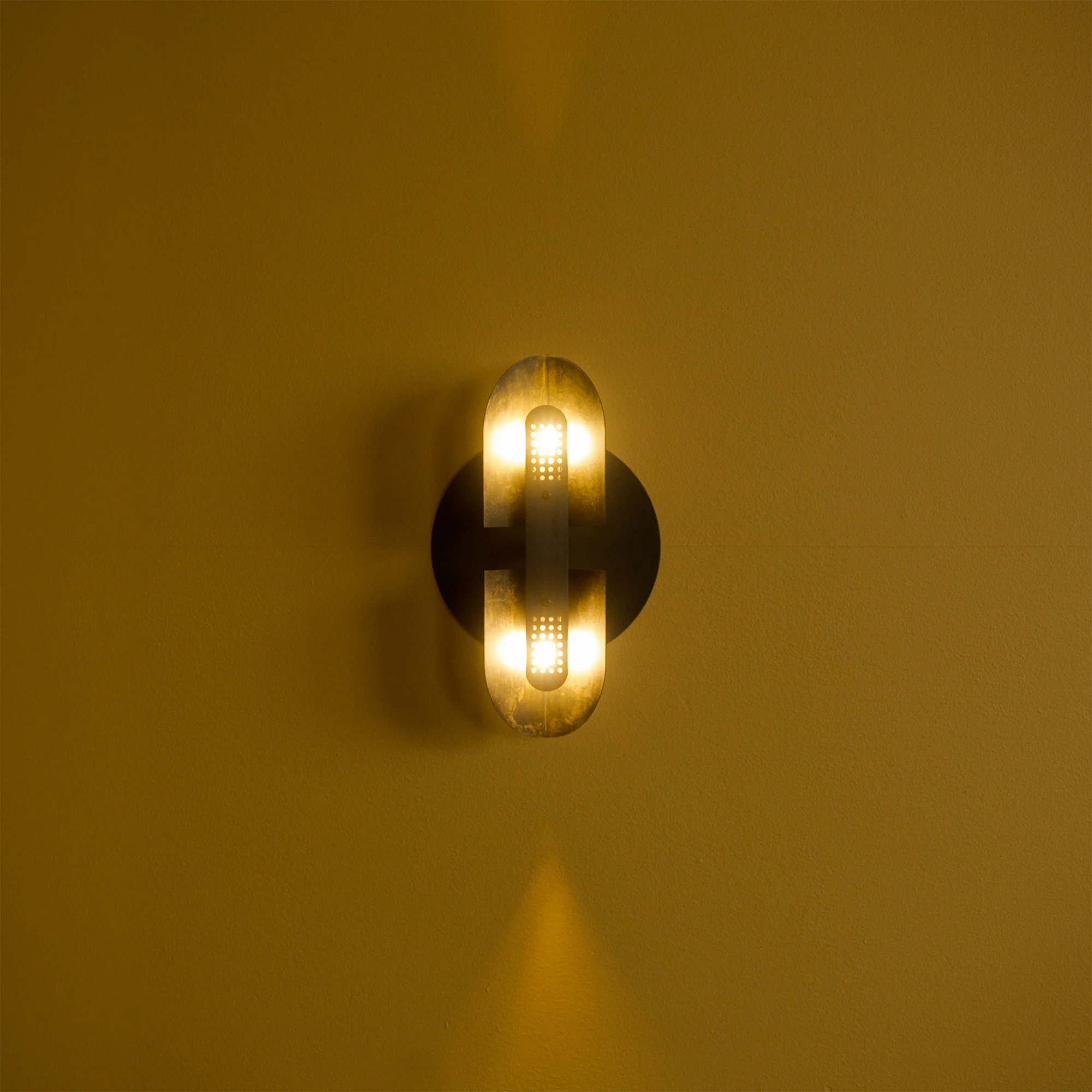Fold Sconce options shown here: Black patina finish. Perforated cover. Large backplate.