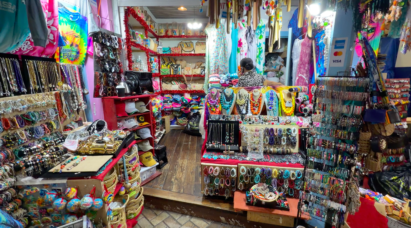 a stall inside the straw market with jewlery, t-shirts and wood carvings for sale
