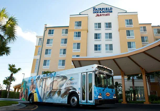 a SeaWorld shuttle bus picks up passengers outside the Fairfield Inn Orlando.