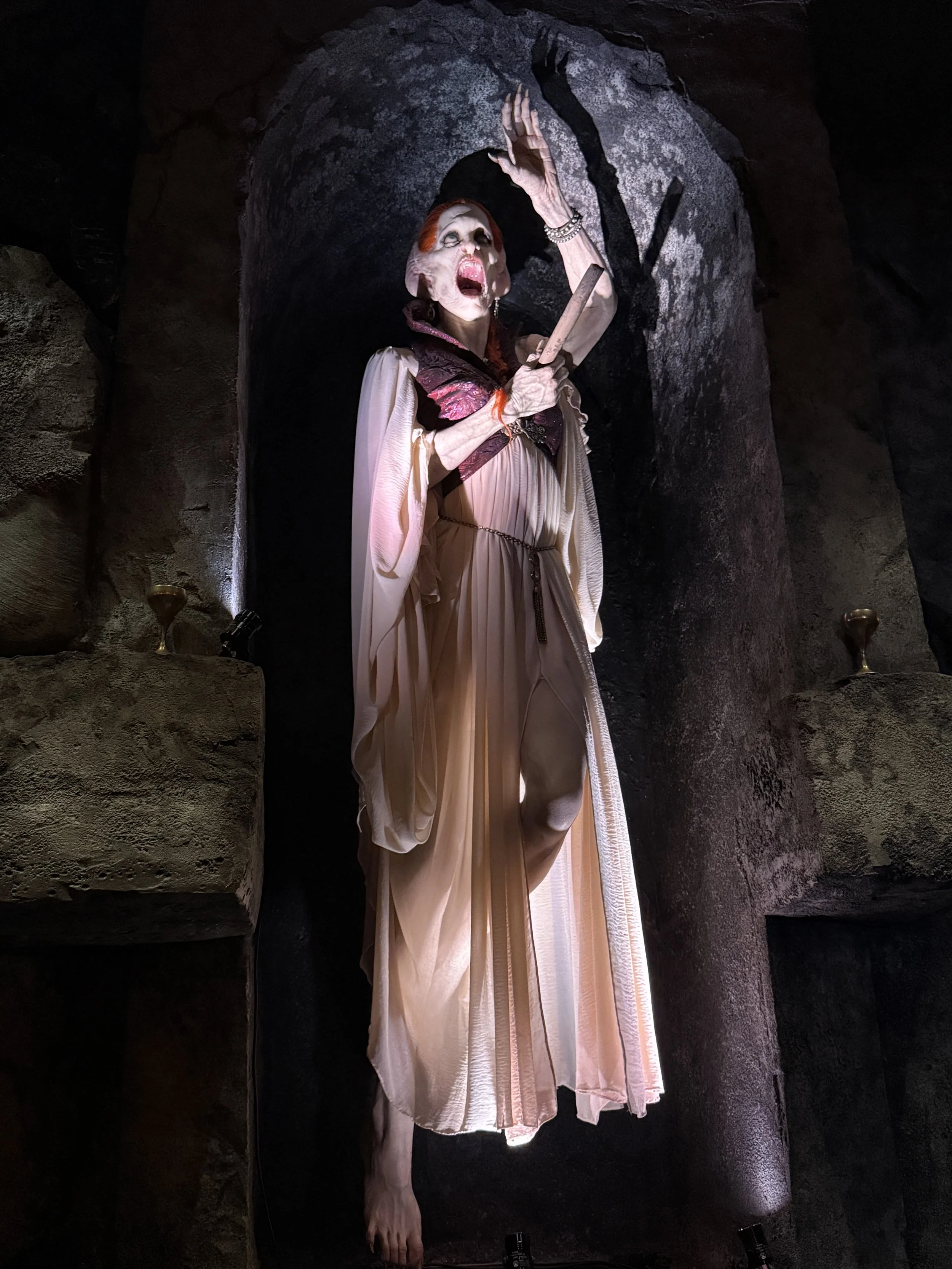 Das Steakhaus at Epic Universe features vampire figures and artwork throughout. Here is a vampire with a stake through her heart