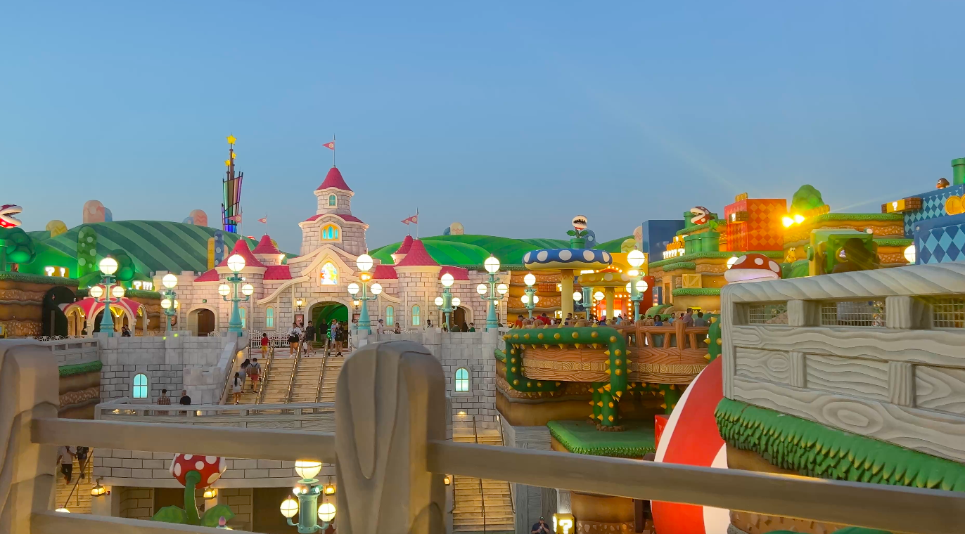Super Nintendo World at Epic Universe at night, showing the castle in the background