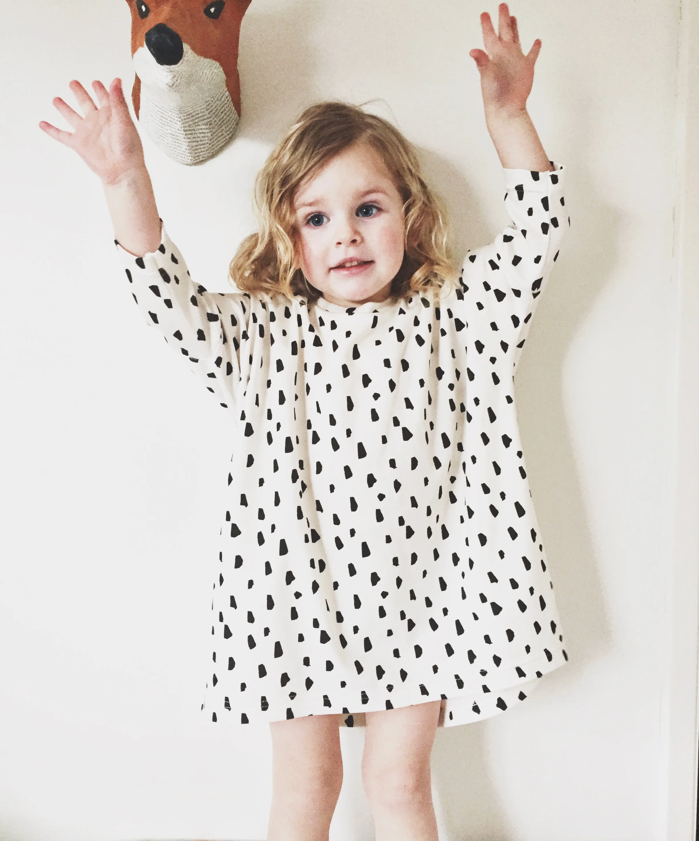 girl modeling black and white tunic dress