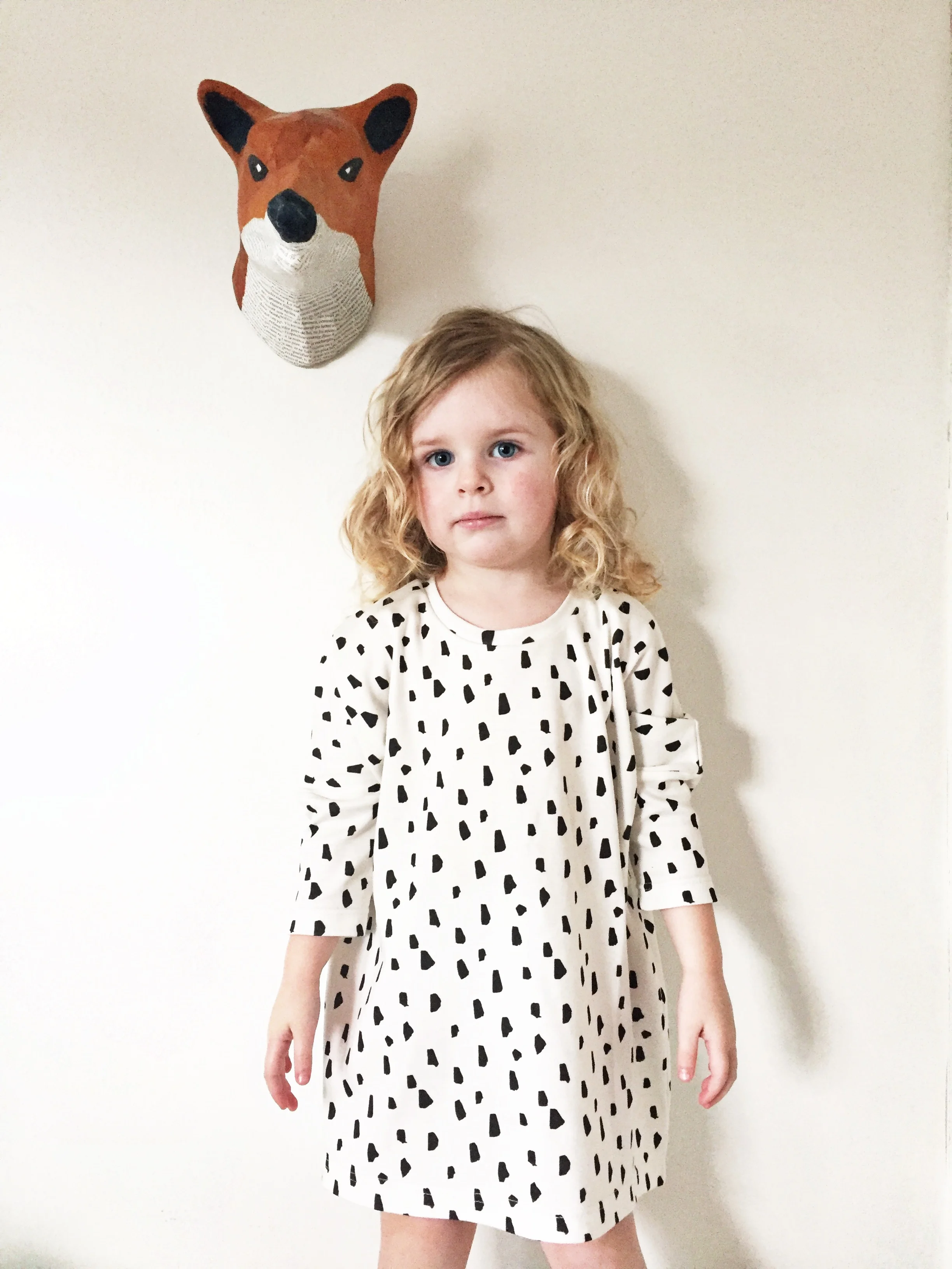 girl modeling black and white tunic dress