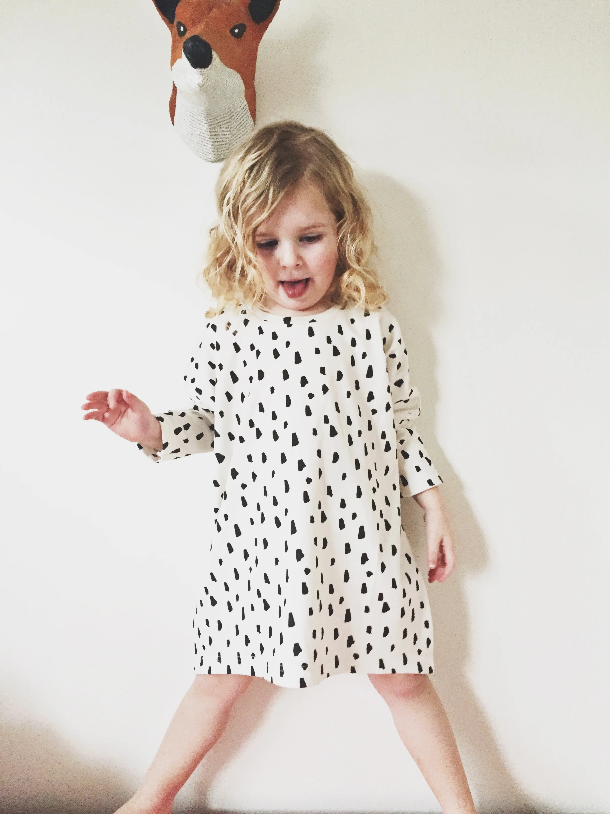 girl modeling black and white tunic dress