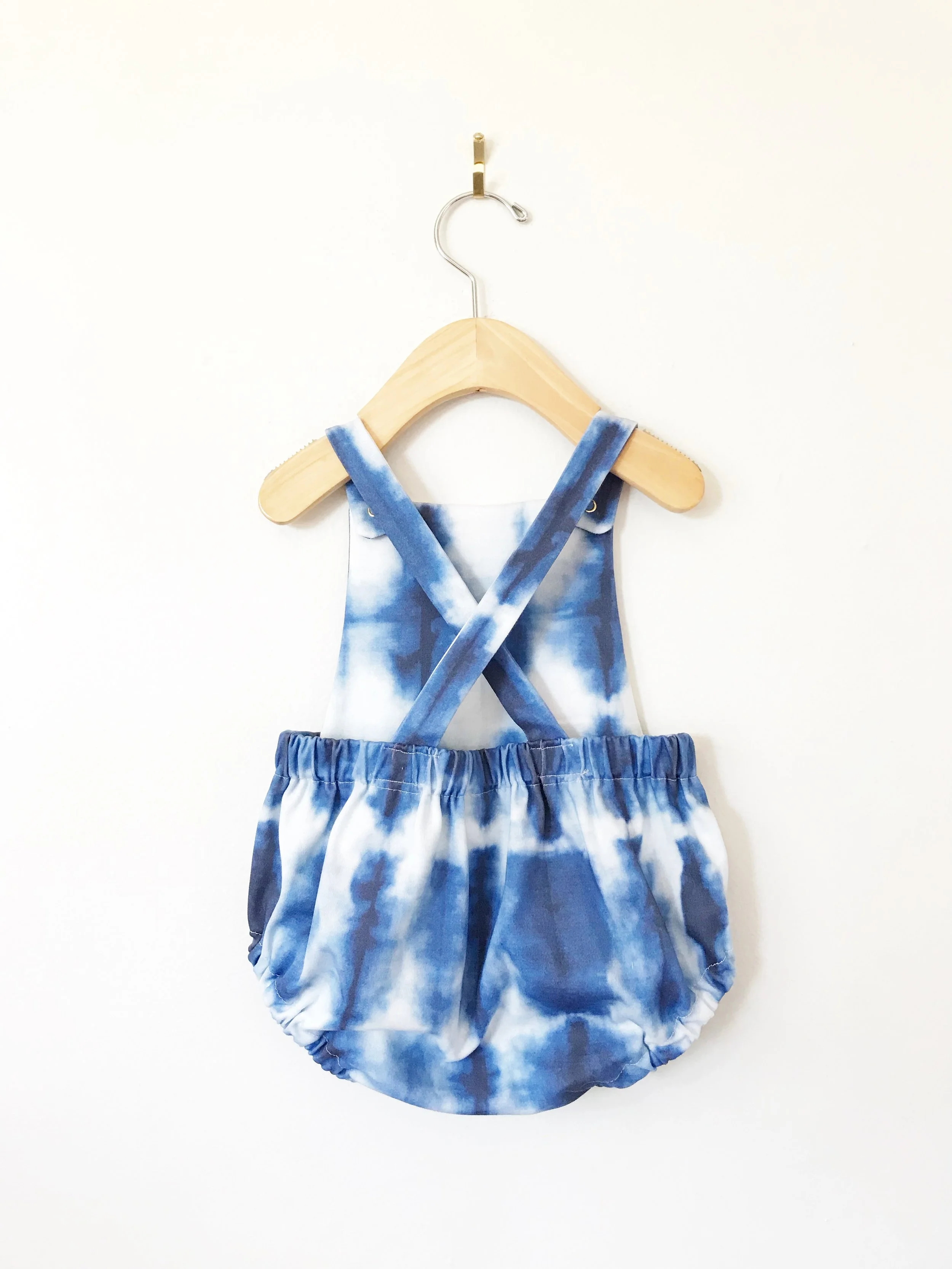 baby cross back romper in blue and white shibori print
