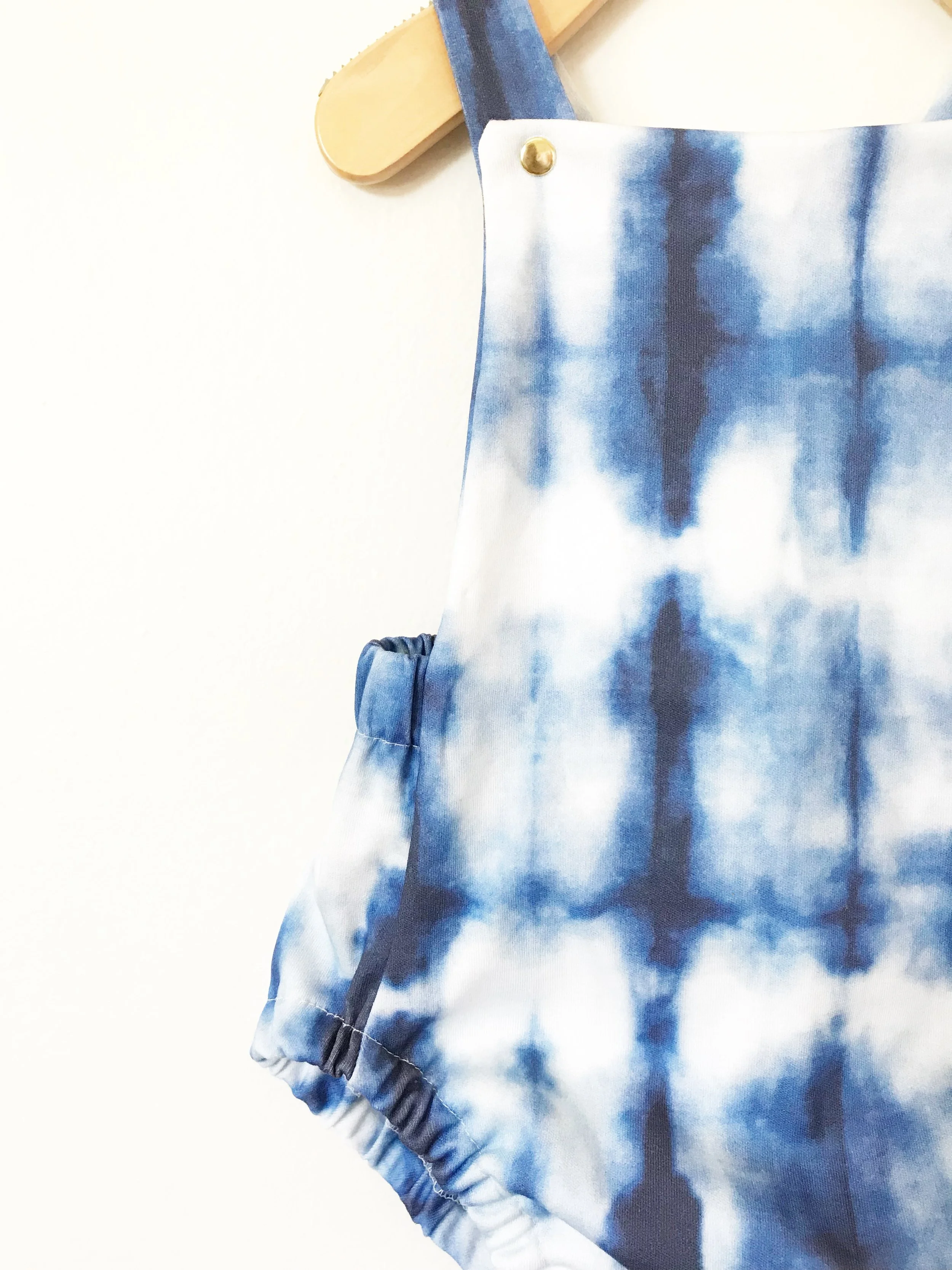 baby cross back romper in blue and white shibori print