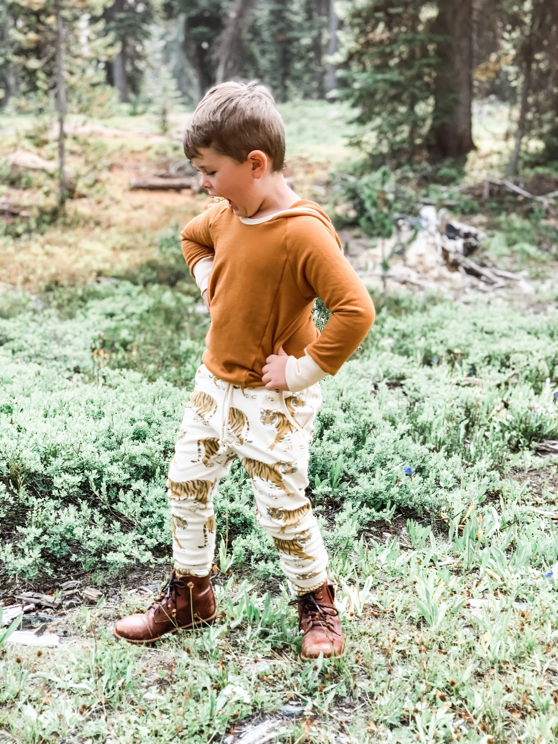 boy modeling joggers with white background and yellow tigers