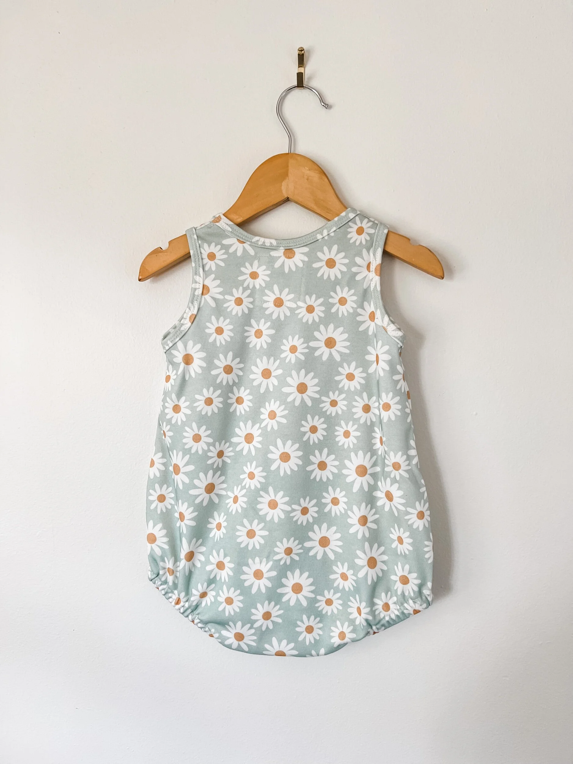 baby bubble romper  with blue background and white daisies
