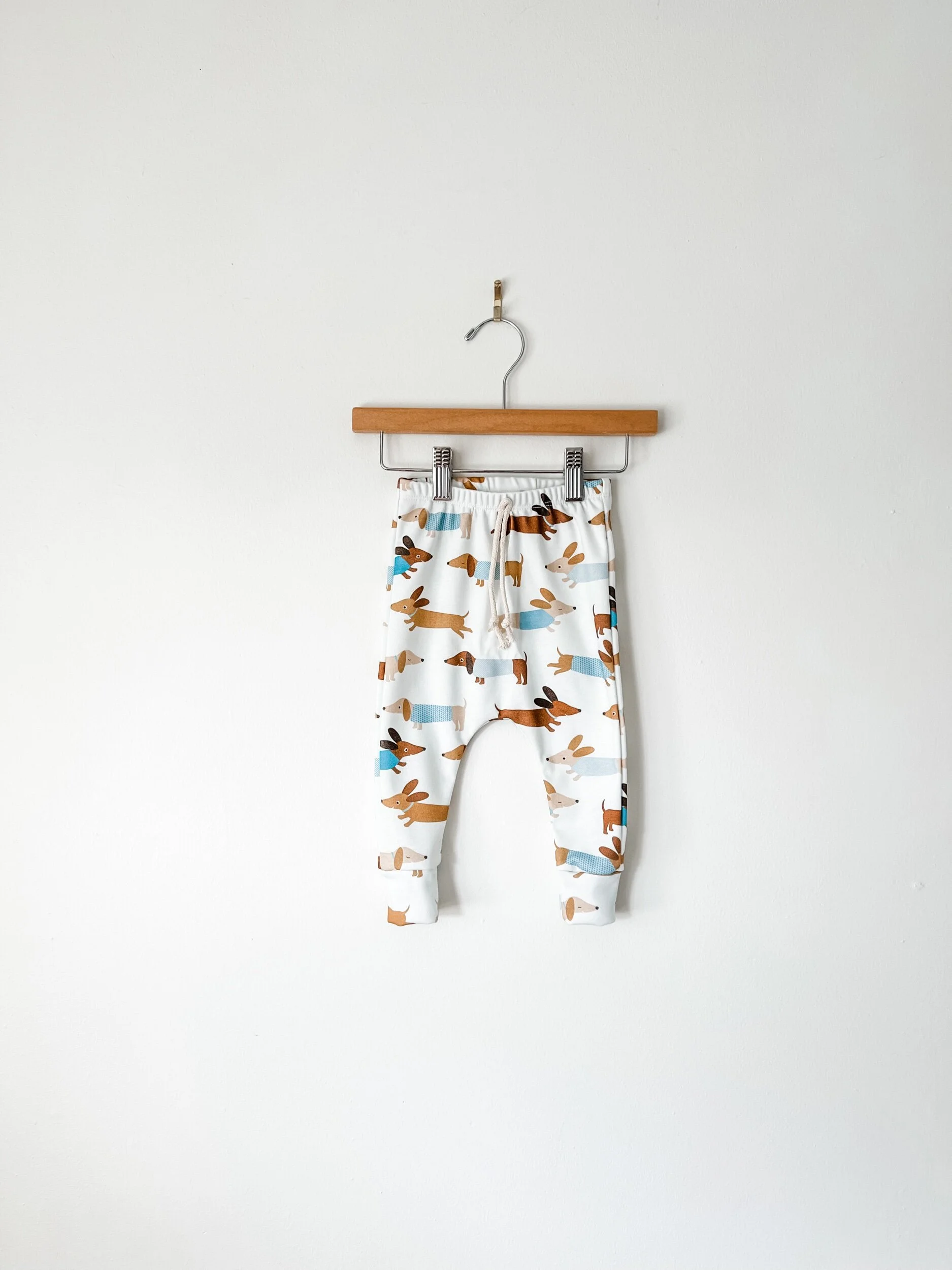 kids joggers in white with brown wiener dogs dressed in blue