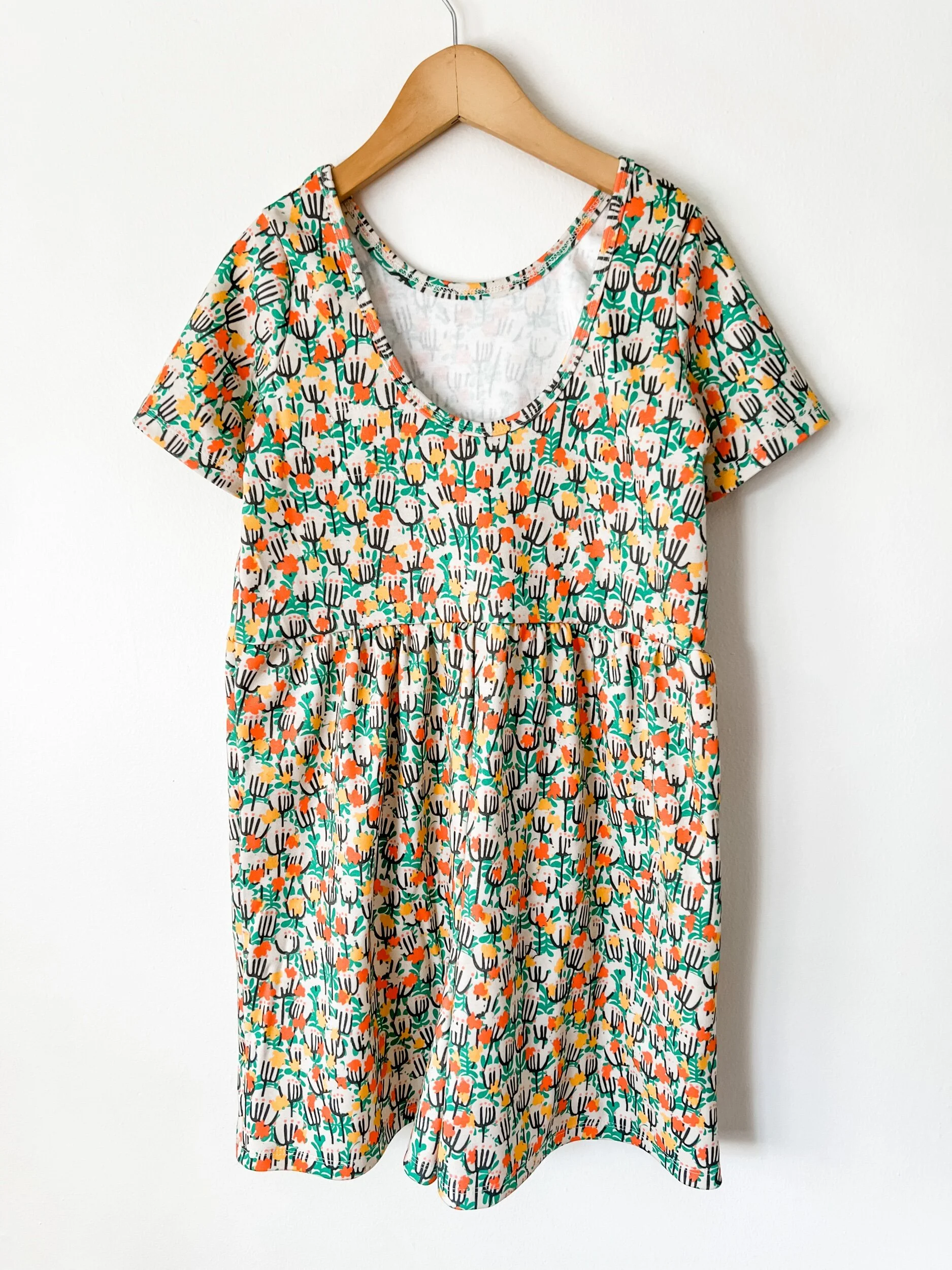 girls scoop back romper in green, yellow and red floral print