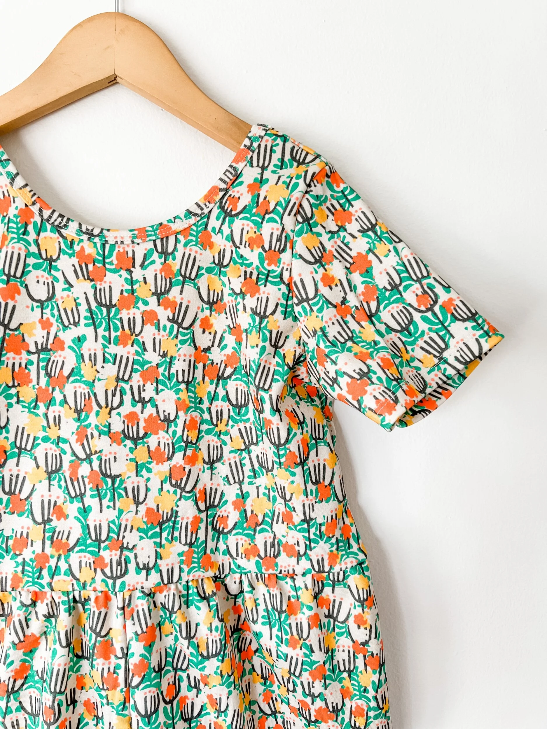 girls scoop back romper in green, yellow and red floral print