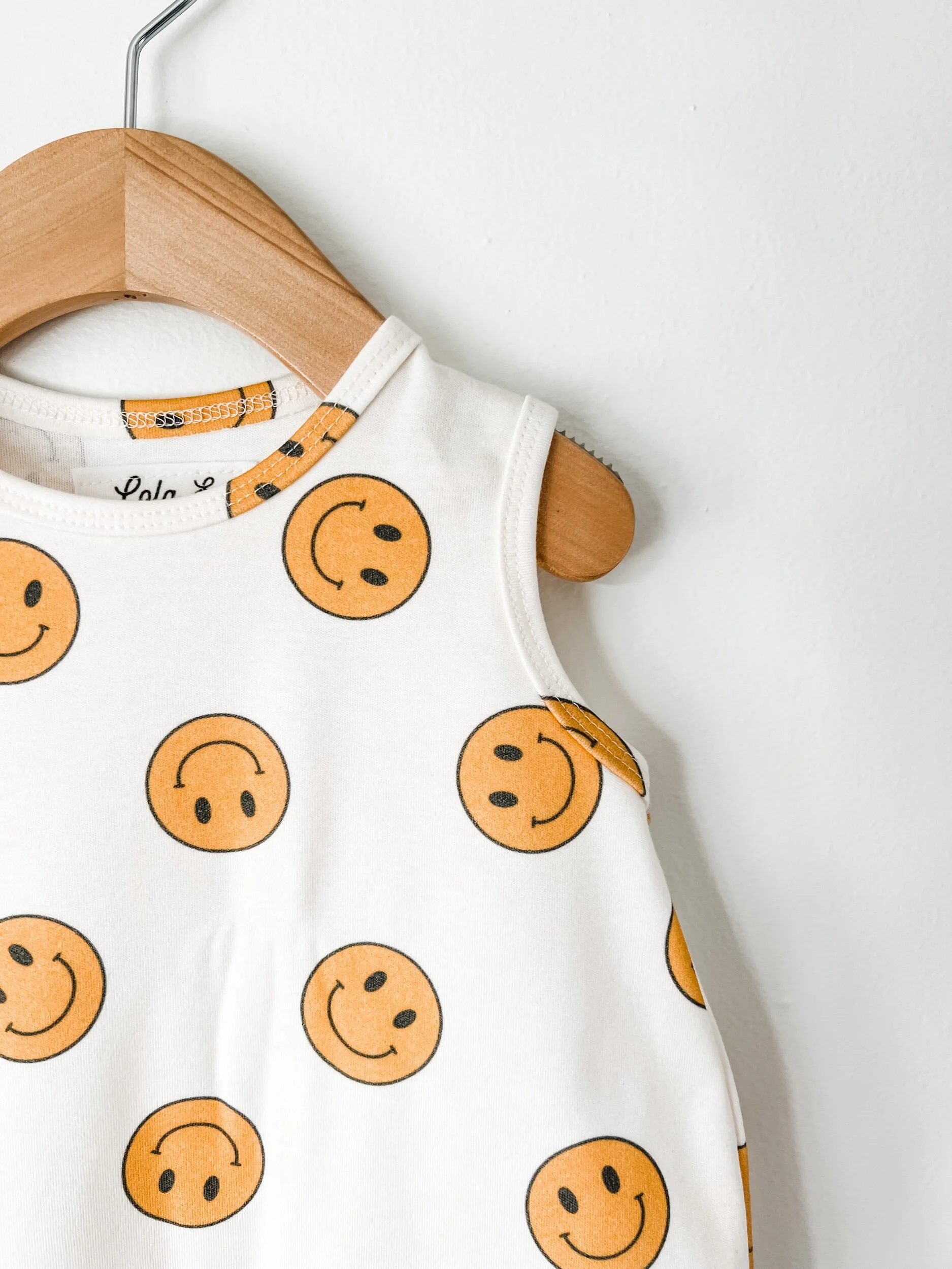 baby romper in white with yellow smiley face