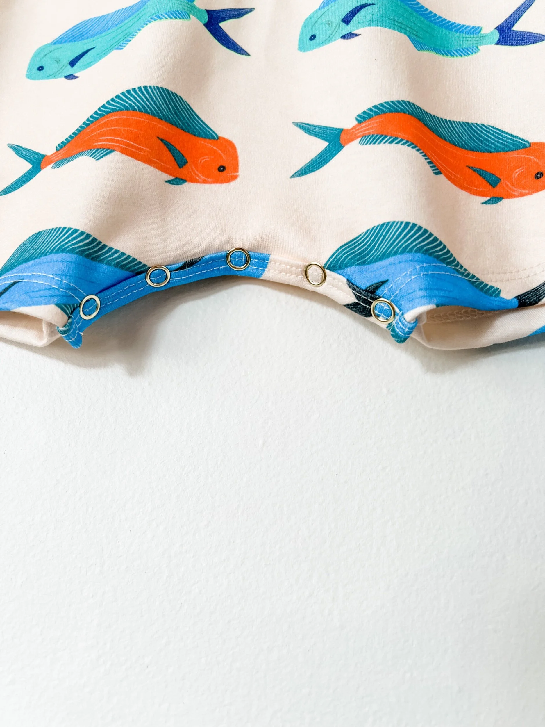 baby romper in off white with blue and red mahi mahi