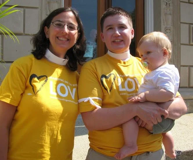 Rev. Melissa Carvill Ziemer and Rev. Evin Carvill Ziemer stand with their child after joining protests in July 2014 to urge President Obama to take Executive Action to stop deportations.