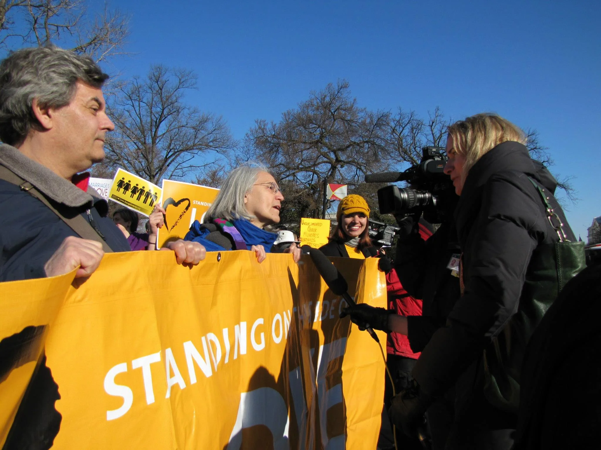 The Love People speak with the media in March 2013 outside the Supreme Court during the hearing for marriage equality cases.