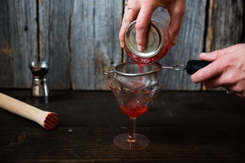 Double-straining using a fine mesh sieve.