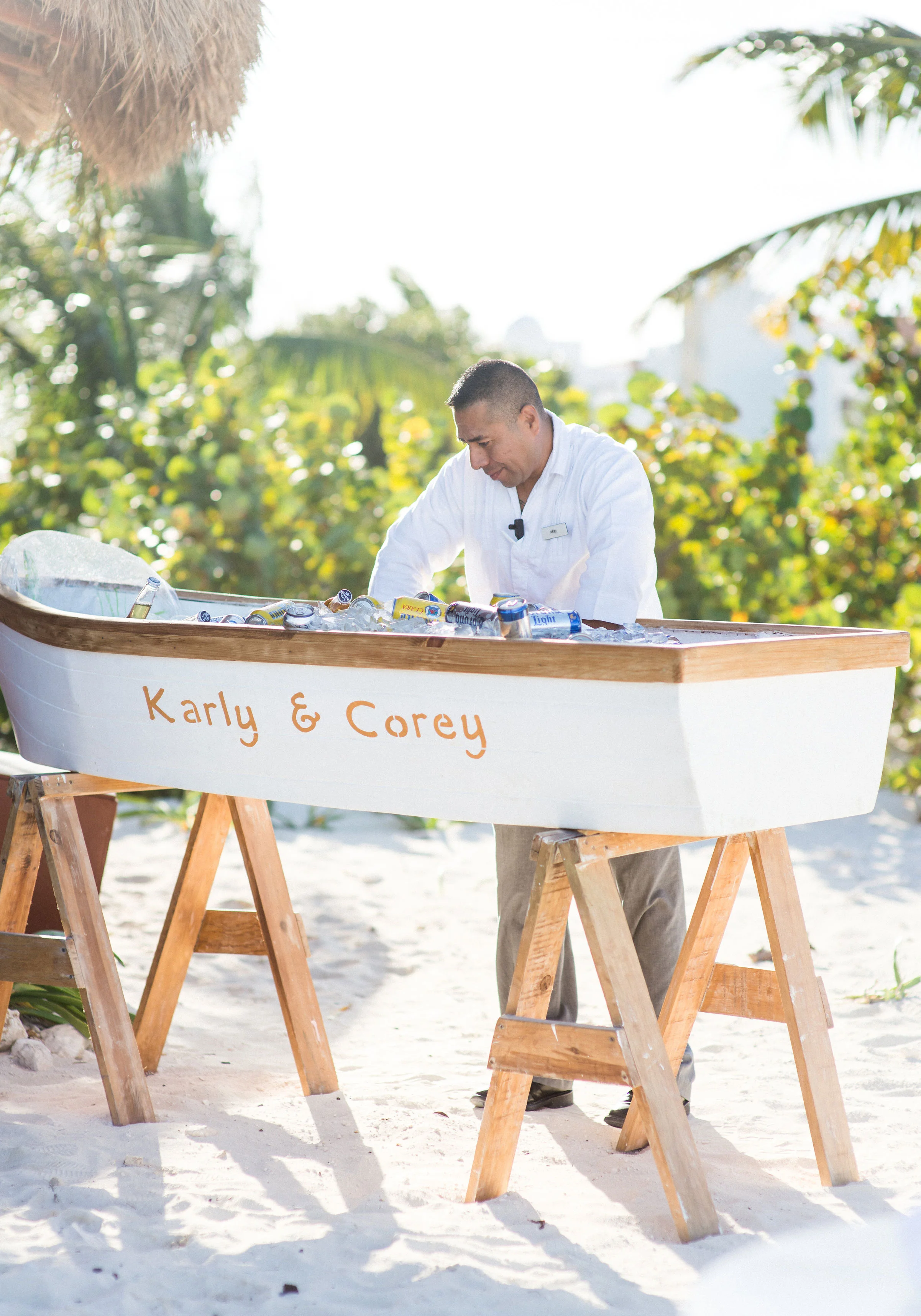 Destination wedding in Mexico, Cocktail hour on the beach with beers in a boat.