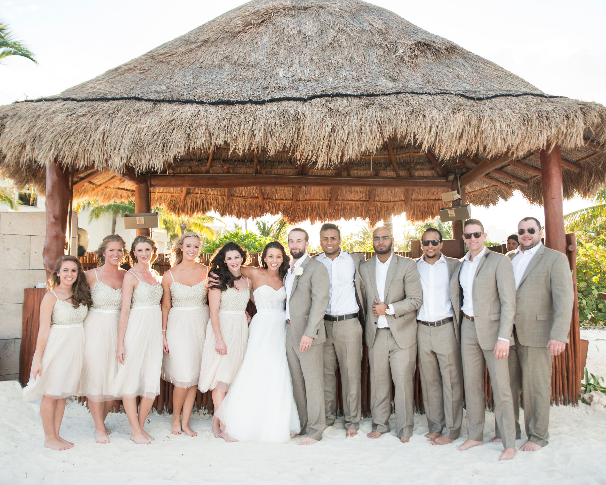 Destination wedding in Mexico, Wedding party at cocktail hour in a tiki hut.