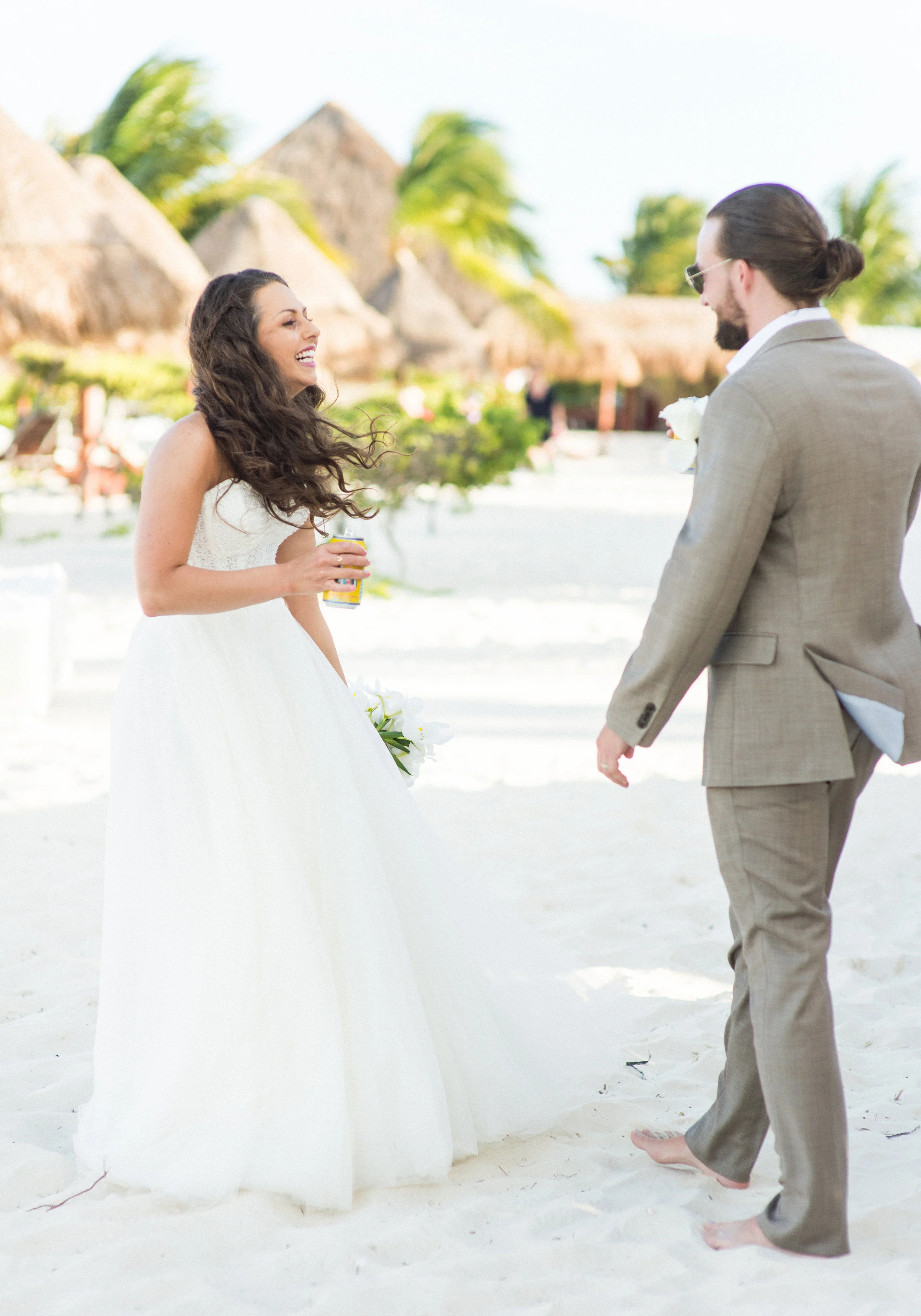 Bride & Groom at their cocktail hour on the beach. Destination wedding in Mexico.