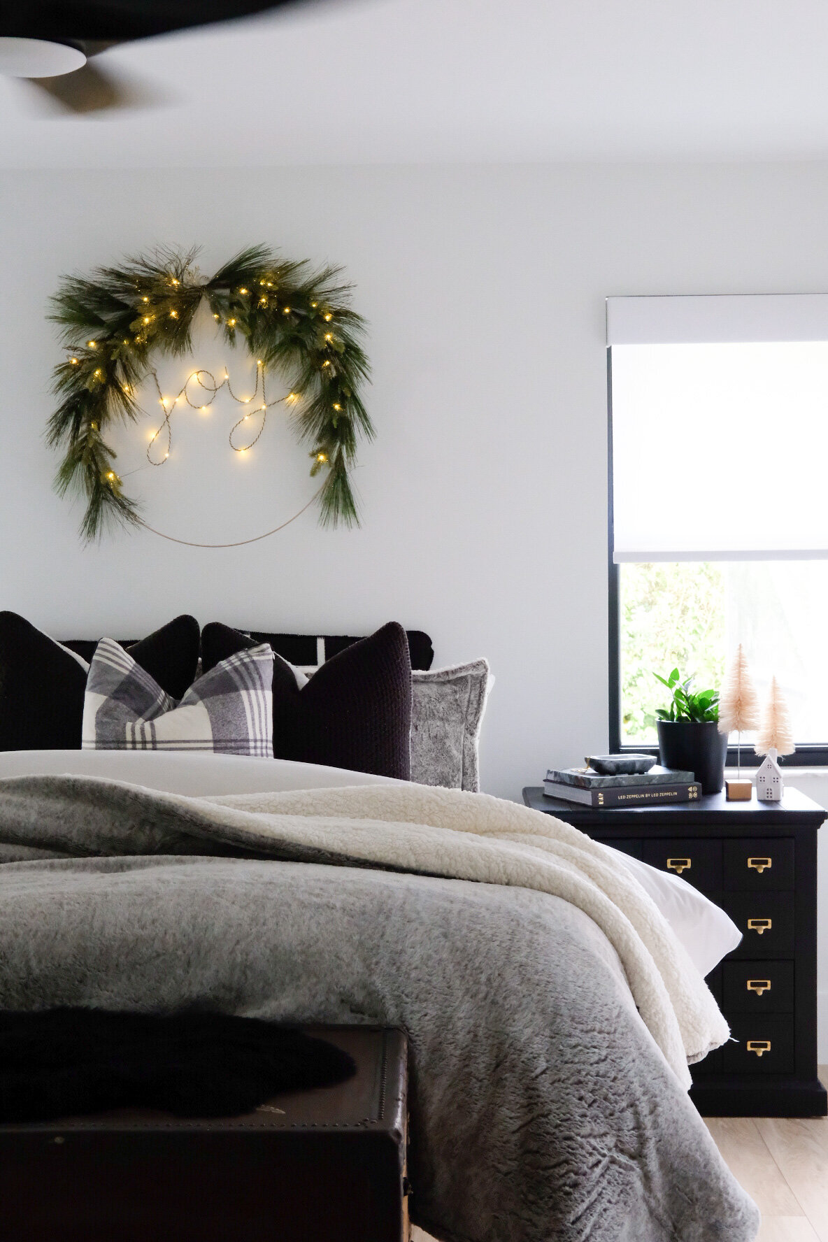 https://images.squarespace-cdn.com/content/v1/5449a23fe4b04f35b928c028/1604972679172-6DSTCZE9YWEJ6RNI4FLH/Me+%26+Mr.+Jones+Christmas+decor+2020.++Joy+lit+wreath+from+Target.++Faux+fur+comforter%2C+black+and+white+neutral+bedding.++Black+and+white+bedroom.