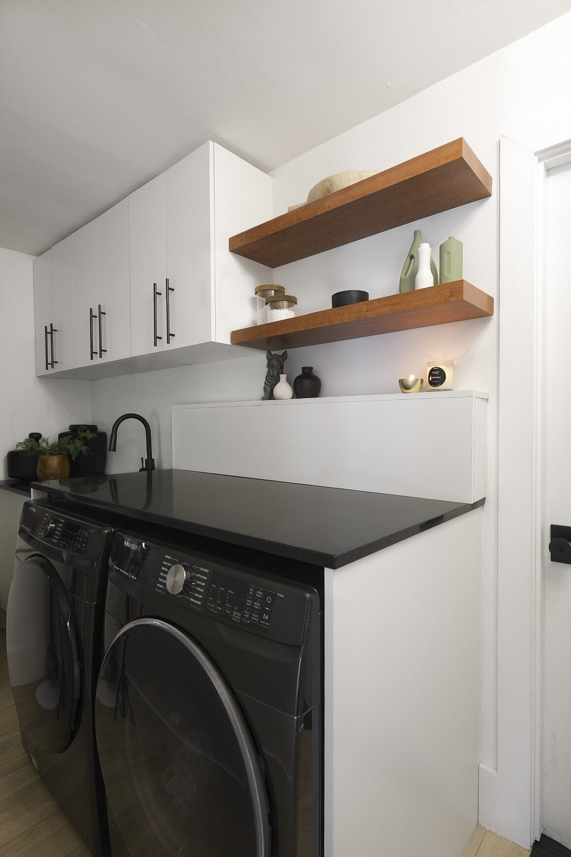 Tailored Living laundry room makeover. Black and white laundry room.  White cabinets, black hardware, black sink.  Me & Mr. Jones laundry room.