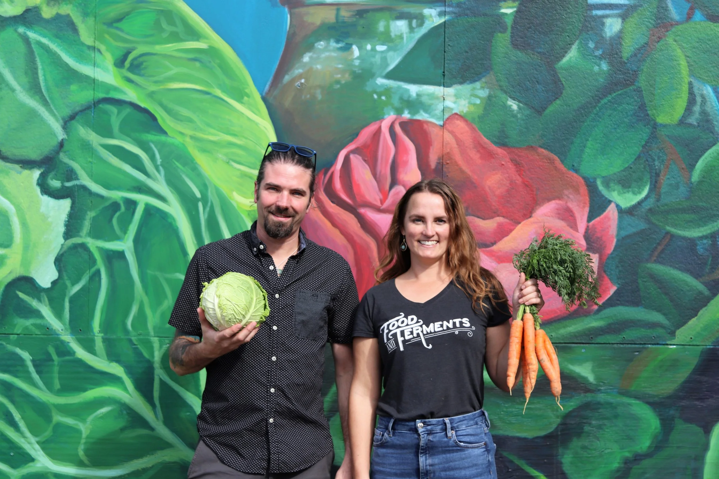 Carly and Dave in front of mural with veg gothic.JPG