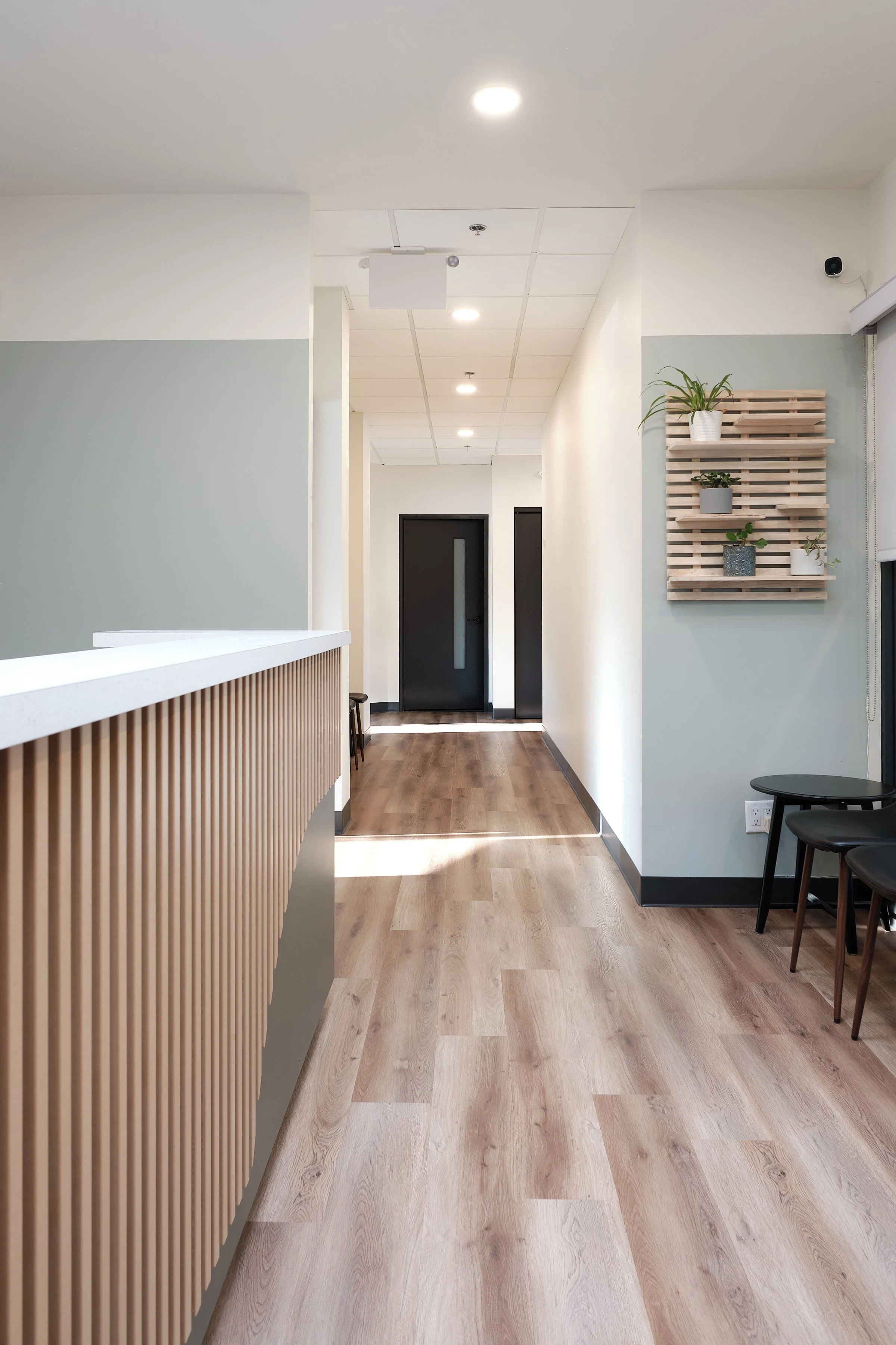 interior photograph showing a slat desk and hallway with natural light in psycholgist office in Edmonton, Alberta.
