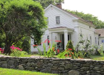 A Greek Revival Cape - most likely located in the Northeast.