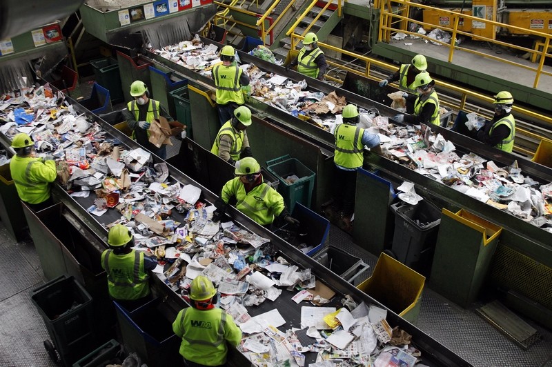 Workers sorting recycling at a recycling center