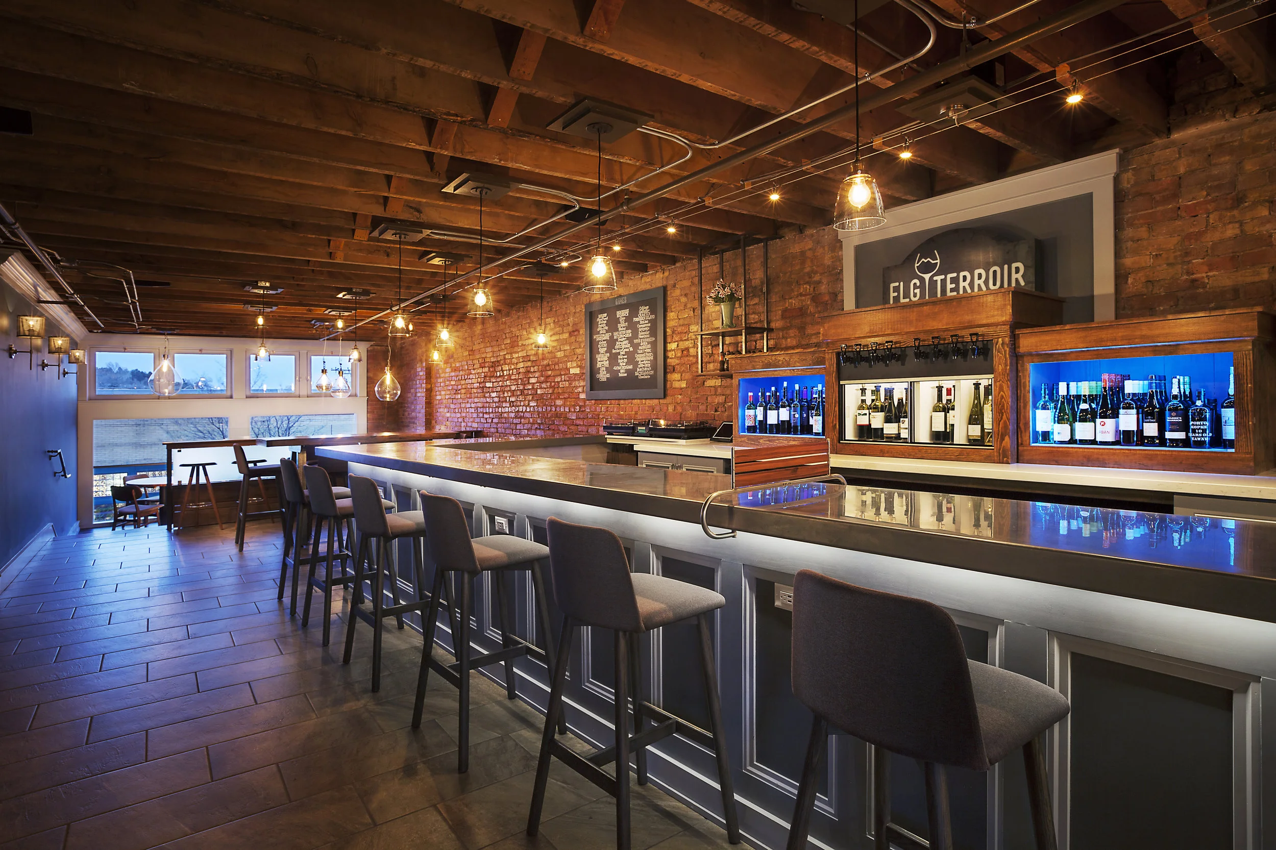 Custom bar and wine dispenser showcase the house wines. The steel bar top is our favorite custom addition done by Silver Tone Fabrications. 