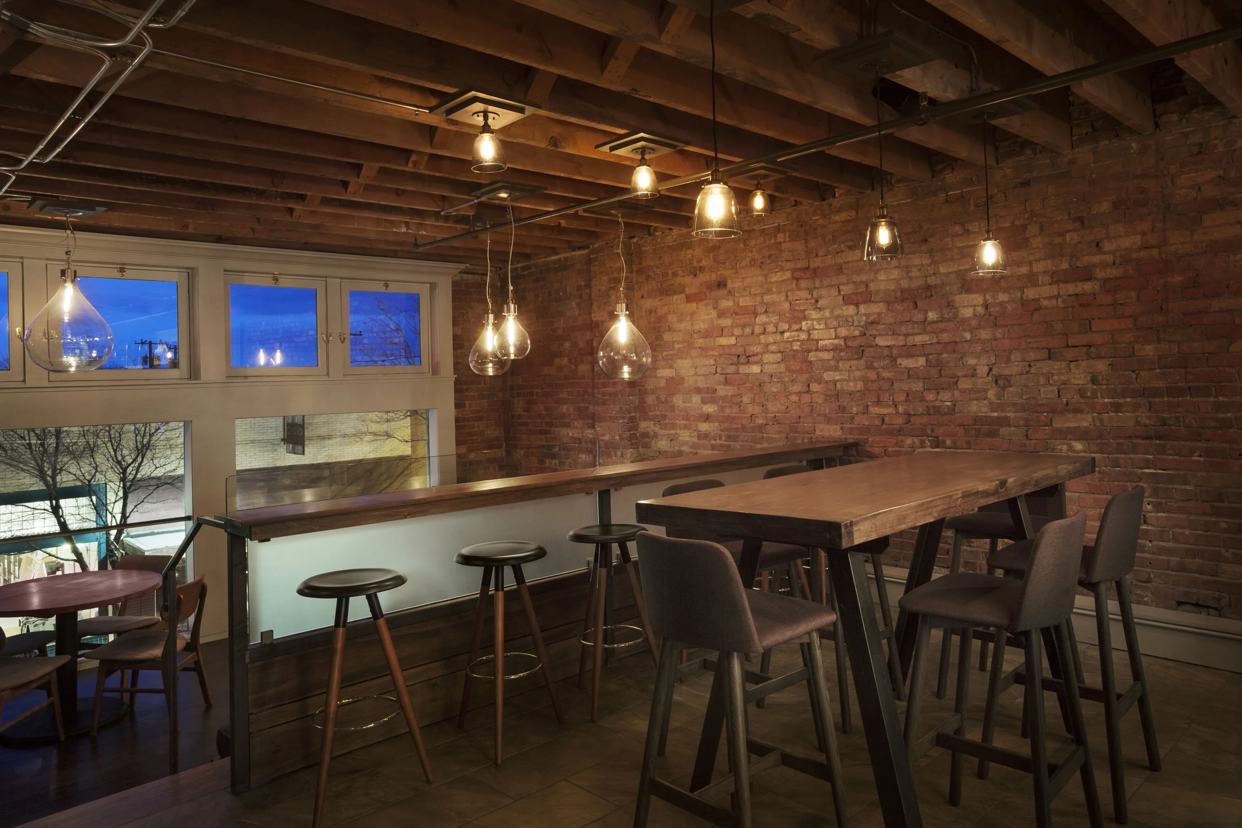 Frosted glass underneath the side bar seating lets in natural light from the picture windows facing the street. 